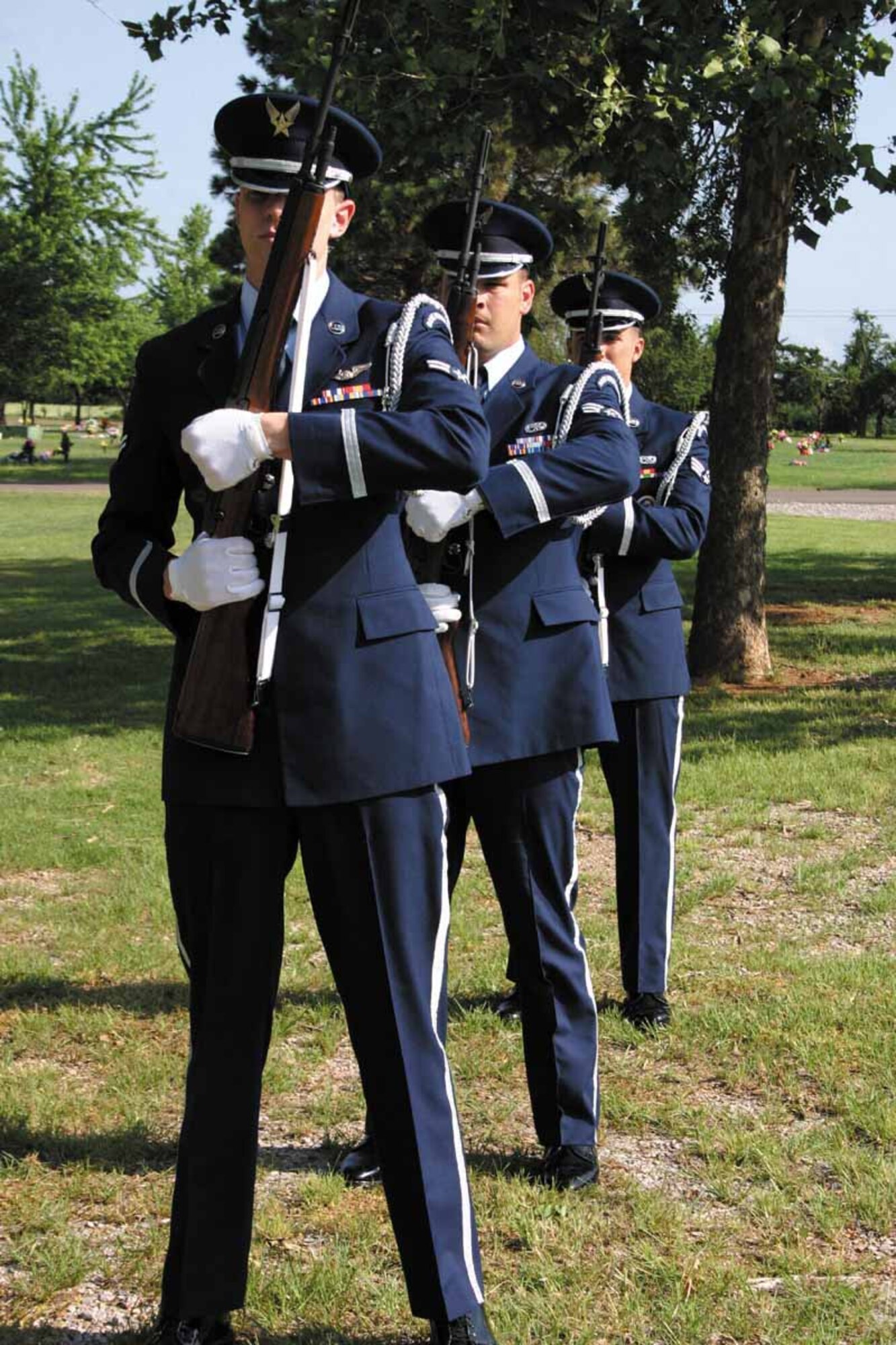 Airman 1st Class Douglals Hale, 963rd Airborne Air Control Squadron, Senior Airman Andrew Stone, 552nd Maintenance Squadron and Senior Airman Eric Crotsley, 552nd MXS, prepare to fire a volley at a funeral detail.  (Air Force photo by Jennifer D'Alessandro)