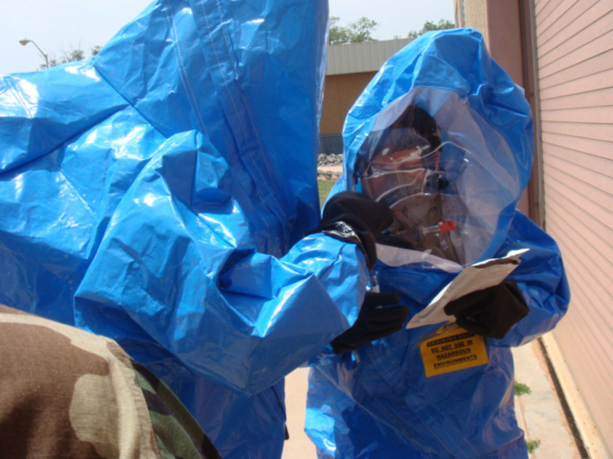 CANNON AIR FORCE BASE, N.M. -- Staff Sgt. Amy Seaton and Airman First Class Richard Riley check a package for radiological contaminants at a scene where a
simulated release of a chemical agent took place here May 28.They then tested the package for biological contaminants. Both are assigned to the 27th Special Operations Aerospace Medicine Squadron. The Medical Functional Exercise took place in conjunction with a series of tabletop exercises here May 28- 29 that tested base and local civilian emergency response capabilities. (Air Force photo by Staff Sgt. Sherron Drayton)     
                               