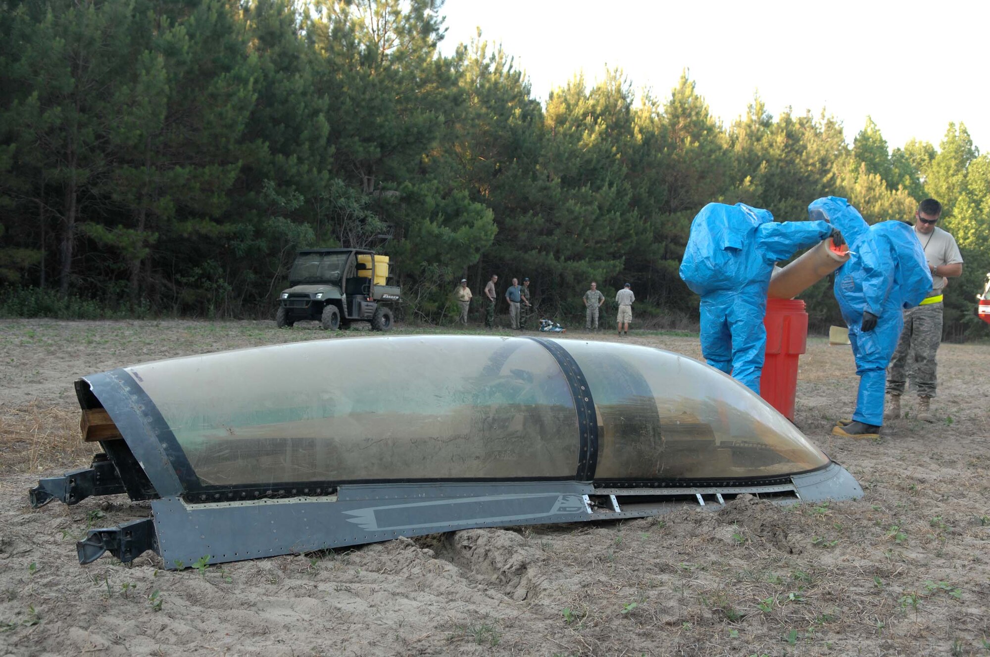 SHAW AIR FORCE BASE, S.C. -- Airman 1st Class Michael George and Master Sgt. Christian Huettmann, 20th Component Maintenance Squadron fuels systems repair specialists, secure a hydrazine tank from a simulated F-16 crash during a major accident response exercise June 6. The MARE prepares Airmen and emergency responders from Shaw AFB on different scenarios for real world operations. (U.S. Air Force photo/Airman 1st Class Matthew Davis)