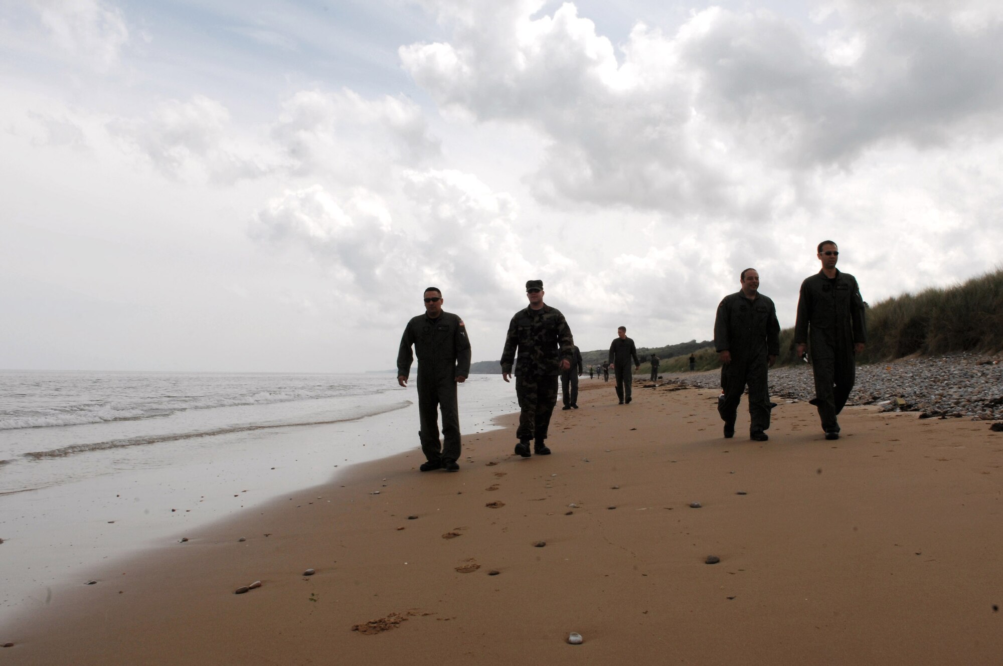Airmen walk along Omaha Beach as part of the weeklong commemoration of the D-Day invasion June 5 in Normandy, France. More than more than 9,000 allied soldiers were killed or wounded on this 50-mile stretch of beach, but it marked the beginning of the end of Nazi Germany during World War II. (U.S. Air Force photo/Airman 1st Class Amber Bressler) 
