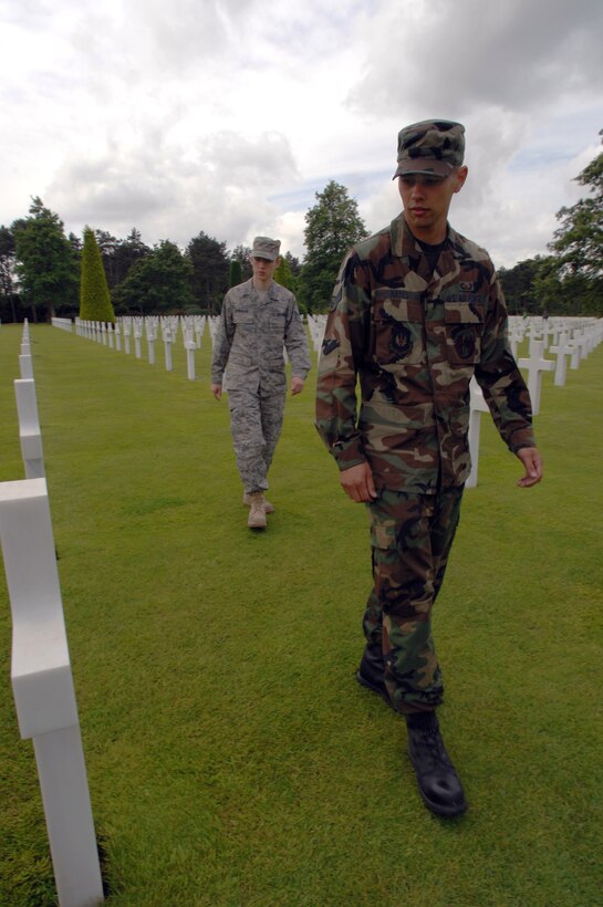 Staff Sgt. Jacob Dowrard (left) and Airman 1st Class Mark Hayes walk through the Normandy American Cemetery and Memorial June 5 in Saint Larent-sur-Mer, France. The grounds hold the remains of more than 10,000 American servicemen and women, and are situated on the bluffs above Omaha Beach. Sergeant Dowrard is an integrated aviation specialist and Airman Hayes is a crew chief, both from the 86th Aircraft Maintenance Squadron at Ramstein Air Base, Germany (U.S. Air Force photo/Airman 1st Class Amber Bressler) 