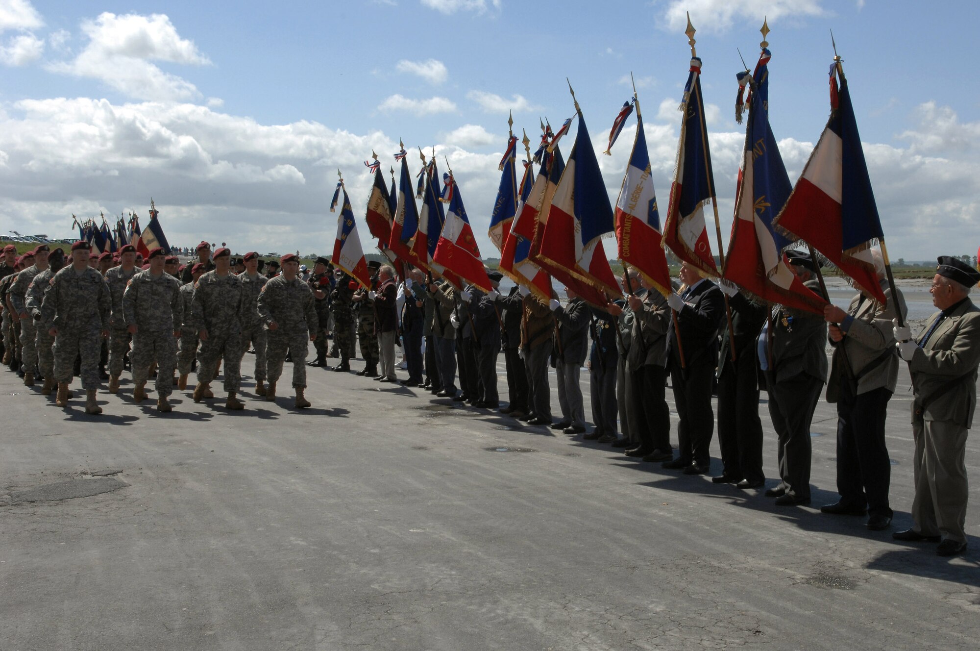 Soldiers and Airman from the Southern European Task Force march in formation in front of World War II veterans from the Normandy invasion June 4 in Mont Saint Michel, France. On June 6, 1944, 160,000 allied troops began landing on the beaches of Normandy, France, for Operation Overlord, otherwise known as the D-Day invasion. More than 9,000 allied soldiers were killed or wounded on the 50-mile stretch of beach, but it marked the beginning of the end of Nazi Germany. (U.S. Air Force photo/Airman 1st Class Amber Bressler) 
