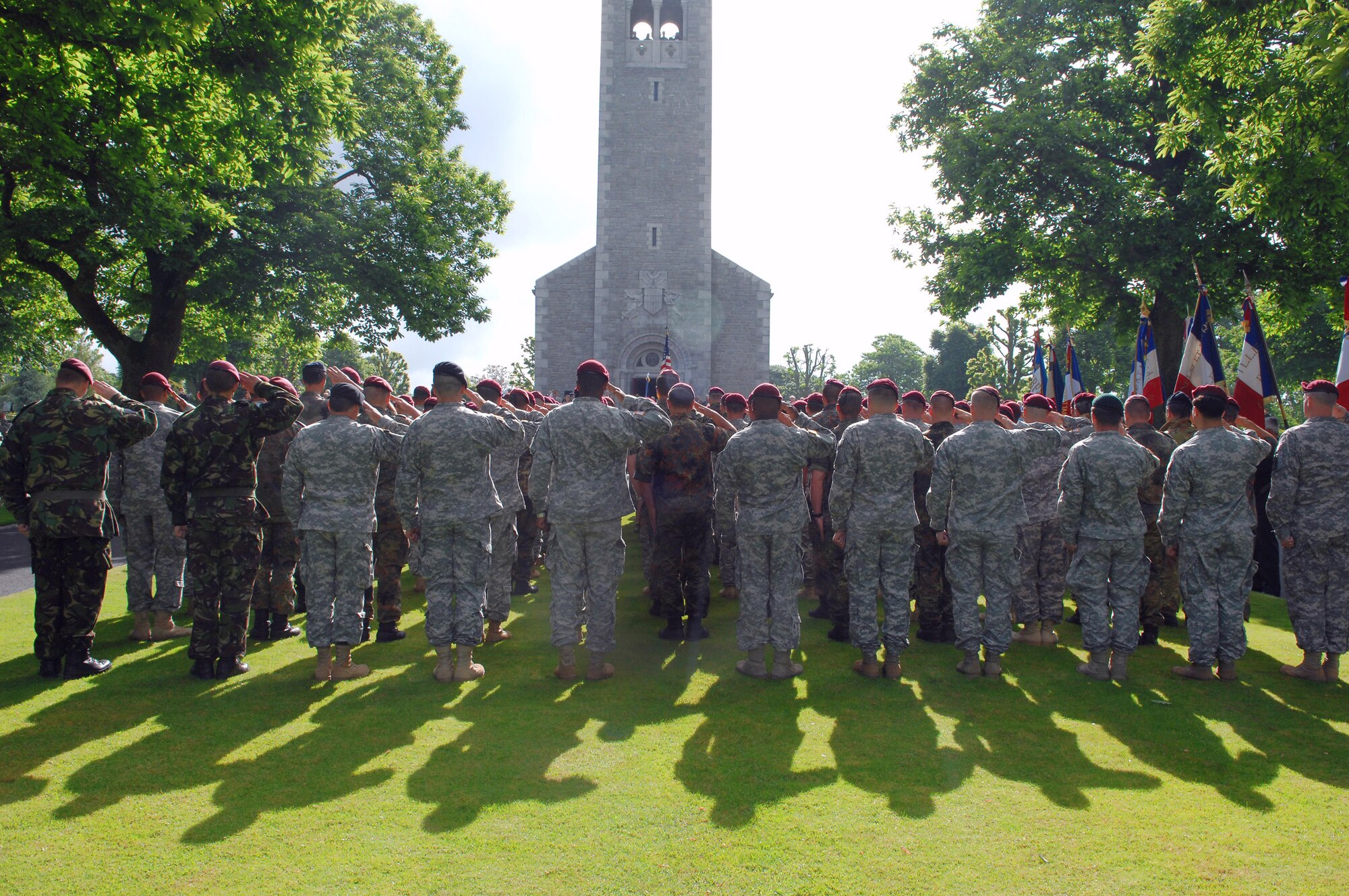 Several hundred American Soldiers and Airmen paratroopers from the Southern European Task Force traveled from Vicenza, Italy, and British servicemembers pay their respects at the Brittany American Cemetery while participating in D-Day Ceremonies June 4 in Normandy, France. More than 4,000 American casualties of World War II are buried at this cemetery and memorial in St. James. (U.S. Air Force photo/Airman 1st Class Amber Bressler) 
