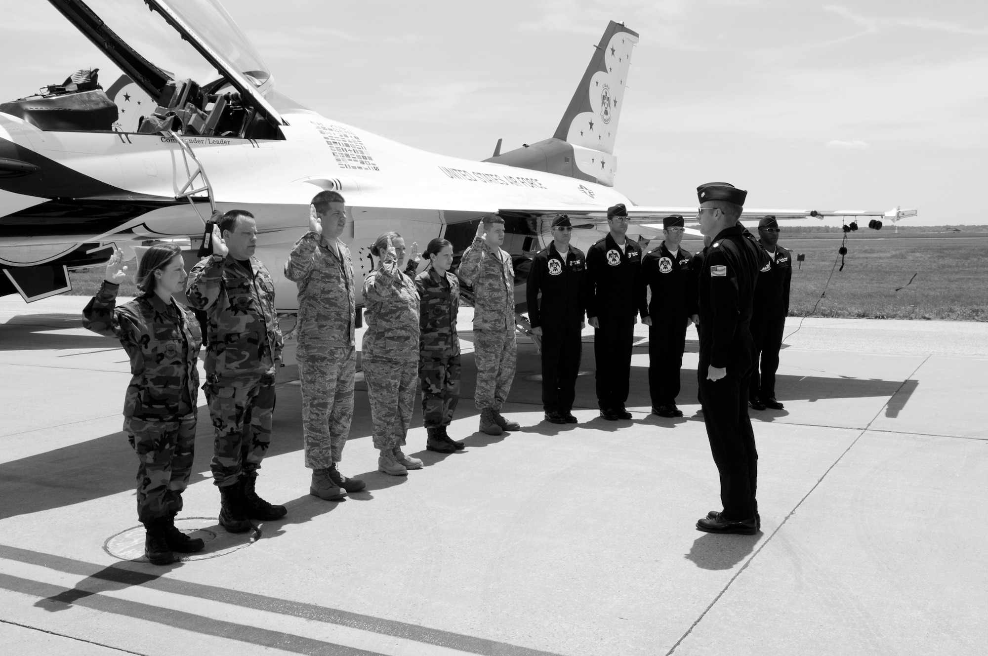 Six Team McGuire Airmen and five U.S. Air Force Thunderbird crewmembers recite the “Oath of Enlistment” administered by Lt. Col. Greg Thomas, the squadron commander/leader and Thunderbird No. 1, May 30 here. (U.S. Air Force photo/Kenn Mann)