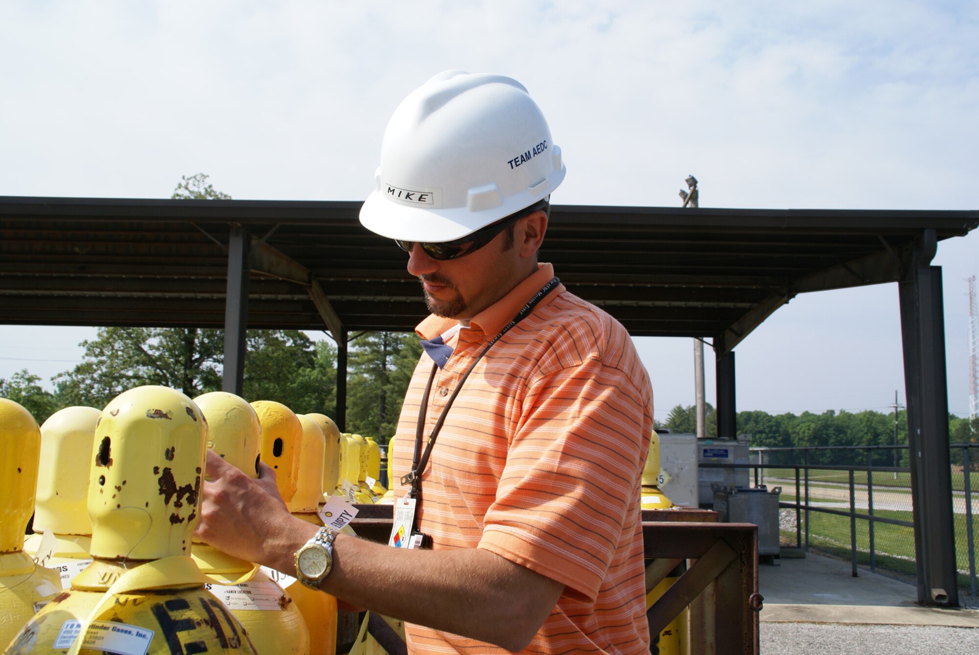 Mike Brumer, Aerospace Testing Alliance’s Hazardous Material Operations Manager for Arnold Engineering Development Center, checks the security of the valve caps on pressurized bottles of hydrogen gas stored in a cylinder yard on the base. He and his five-member team are responsible for the safe procurement, transportation, storage, use and dispensing of a broad array of hazardous materials on base. These include aviation fuel, heavy and light oils, explosives and munitions, and ozone depleting substances. (Photo by Philip Lorenz III)