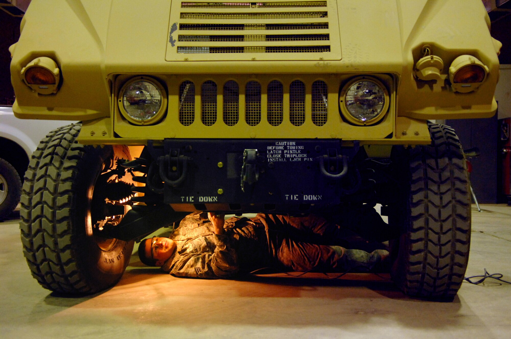 BALAD AIR BASE, Iraq -- Senior Airman James Valdiviez, 332nd Expeditionary Logistics Readiness Squadron vehicle mechanic, looks at the undercarriage of a new humvee here, June 4. New humvees are inspected before they are released to the receiving unit to ensure they are up to specifications and are fully operational. Throughout Iraq humvees are being used for tactical and non-tactical operations. Airman Valdiviez is deployed from Eielson Air Force Base, Alaska. (U.S. Air Force photo/ Senior Julianne Showalter) 