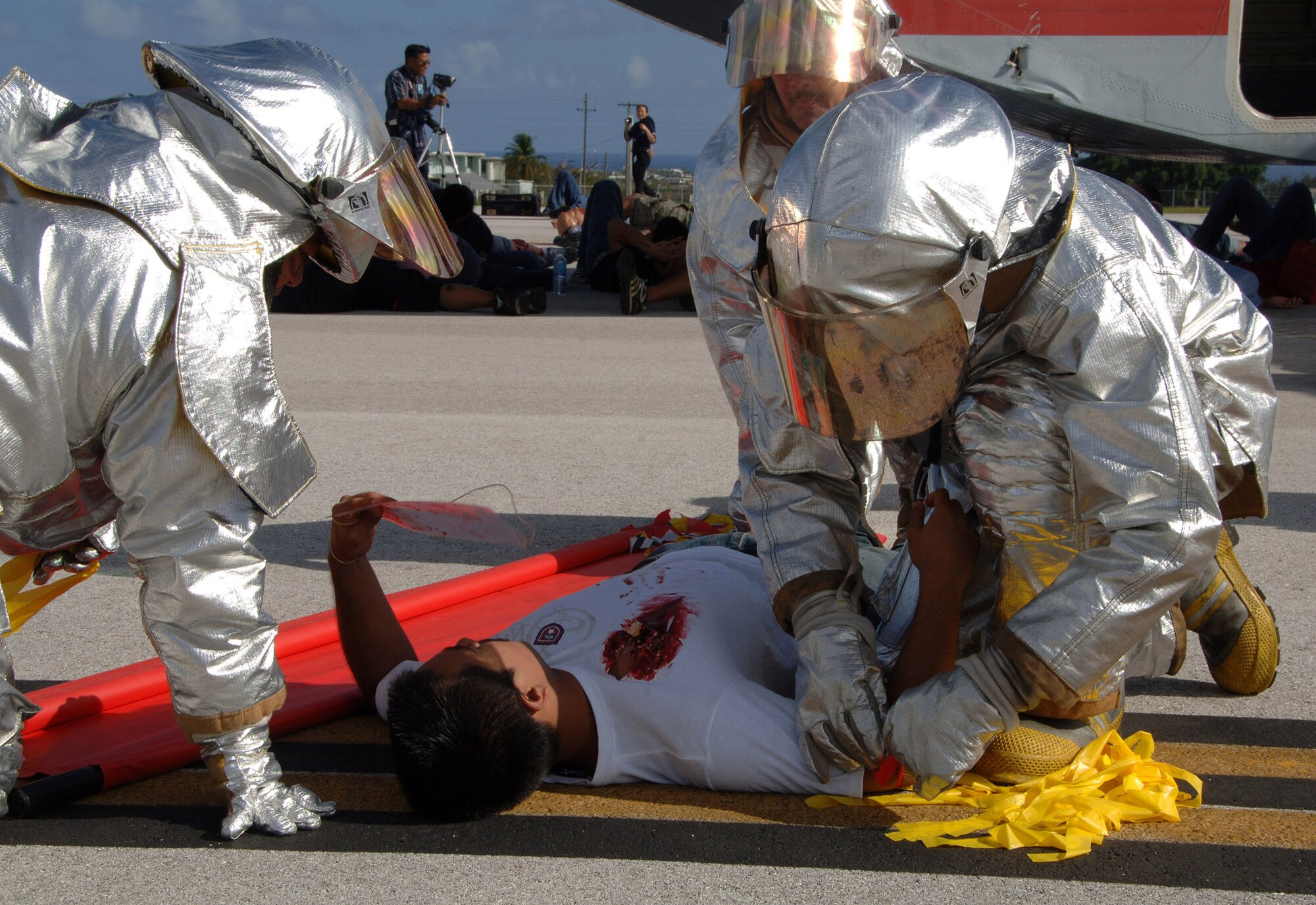 Members of the Guam Fire Department give aide to a victim at this years Full Scale Disaster Drill Exercise at Guam International Airport on June 6, 2008. The crews preformed many tasks that would essentially happen during a real plane crash. The drill started approximately 8:20 a.m. and finished around 11:00 a.m.  (U.S. Air Force photo by Airman 1st Class Courtney Witt)