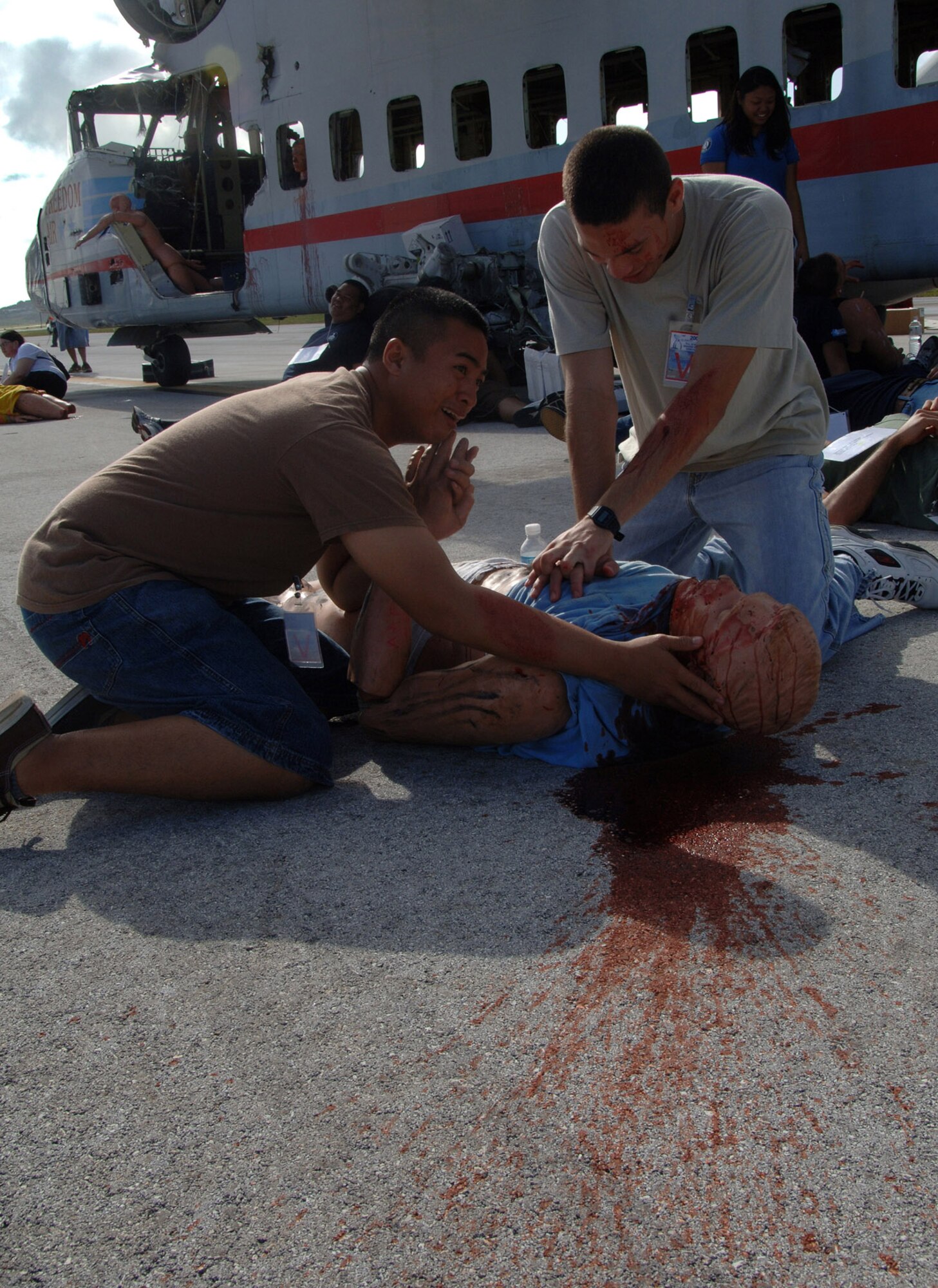 U.S. Air Force Airman First Class Edward Estillore and Airman Michael Purdy practice CPR during this years Full Scale Disaster Drill Exercise at Guam International Airport on June 6, 2008. A1C Estillore and Am Purdy  volunteered to help out with this exercise.  (U.S. Air Force photo by Airman 1st Class Courtney Witt)
