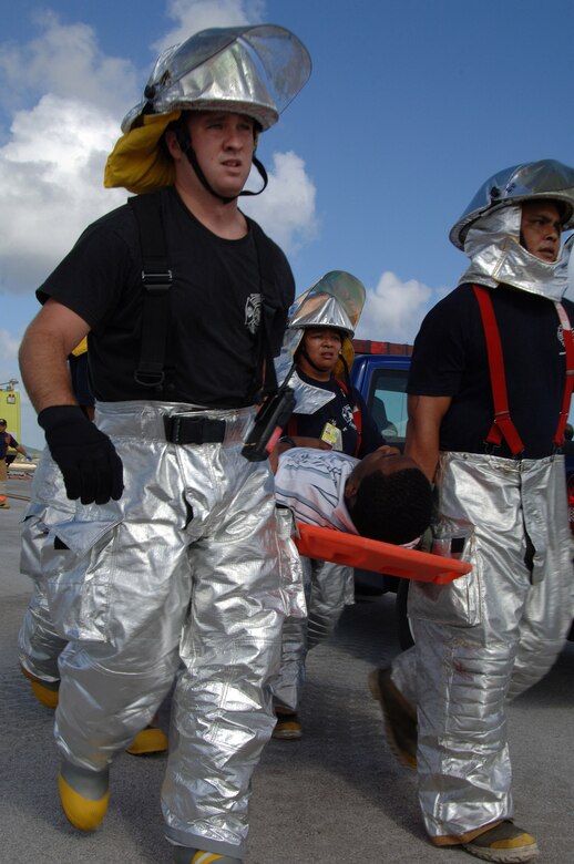 U.S. Air Force Senior Airman Mathew Derheim carries a victim to safety at this years Full Scale Disaster Drill Exercise at Guam International Airport on June 6, 2008. Andersen AFB Fire Rescue Team was one of several Departments that helped out with this disaster exercise. (U.S. Air Force photo by Airman 1st Class Courtney Witt)