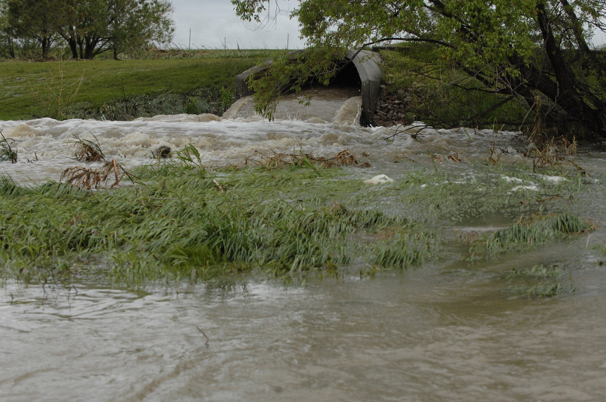 As shown above, heavy rain fall in the Black Hills area, has produced flood conditions in several areas on and off base. Increased rain resulted in the evacuation of more than 20 families from the Box Elder community, which borders Ellsworth. The Black Hills Area Chapter of the American Red Cross has opened a shelter at Douglas Middle School to help support Box Elder residents displaced by flooding. People who live in low-lying areas are advised to pack a bag containing extra clothing, medications and other necessities to prepare for possible evacuation as the rain continues throughout the day. For assistance, residents affected by flooding should contact (605) 342-4010. To learn more about preparing for a disaster or to donate, visit www.blackhillsredcross.org. (U.S. Air Force photo/Airman Matthew Flynn)