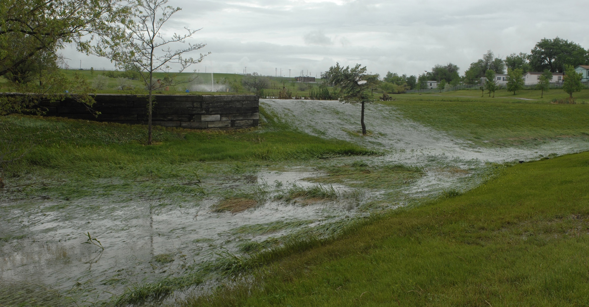 The lake at Ellsworth’s Prairie Ridge Golf Course (above) spills onto the gulf course after several days of rain. This is just part of the severe-weather damage experienced at Ellsworth and throughout the Black Hills as periodic hail and flooding conditions pounded the area throughout the week. The 28th Security Forces Squadron offers advice on staying safe during severe weather conditions at www.ellsworth.af.mil/news/story.asp?id=123101599. (U.S. Air Force photo/Airman Matthew Flynn)