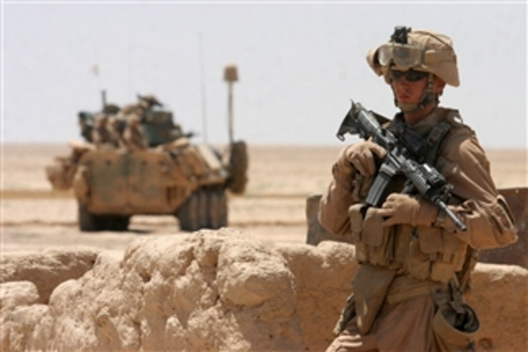U.S. Marine Corps Pfc. Mathew J. Daniels from 1st Platoon, Alpha Company, 2nd Light Armored Reconnaissance Battalion, Task Force Mechanized stands guard as fellow Marines conduct a meeting in the Salad Ad Din province of Iraq on May 20, 2008.  Marines with the battalion are conducting missions to hunt down and rid the northern part of Iraq of insurgents.  