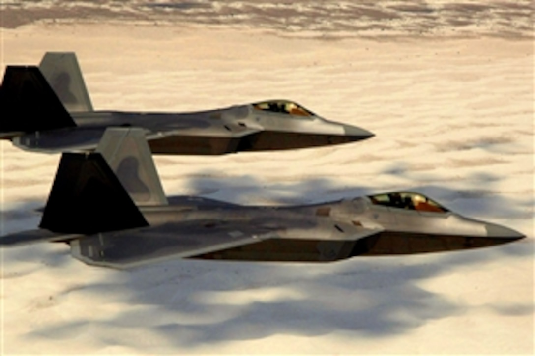 U.S. Air Force Col. Jeff Harrigian, 49th Fighter Wing commander, and Lt. Col. Mike Hernandez, 7th Fighter Squadron commander, fly F-22 Raptors, June 2, 2008, over White Sands National Monument on the way to their home base, Holloman Air Force Base, N.M. 