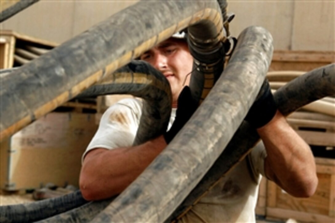 U.S. Air Force Tech. Sgt. David Follmuth reconfigures a fuel hose at Kirkuk Air Base, Iraq, May 28, 2008. Sgt. Follmuth is assigned to the 506th Expeditionary Logistics Readiness Squadron and deployed from Grand Forks Air Force Base, N.D. 
