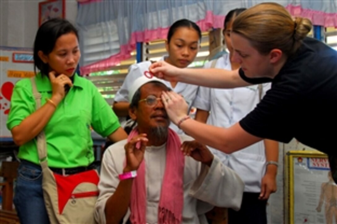 U.S. Air Force Senior Airman Kate Thomas, assigned to the hospital ship USNS Mercy, helps a patient find a suitable pair of glasses during a Pacific Partnership 2008 medical civic action program at a school in Cotabato, Philippines, June 3, 2008. The USNS Mercy is on a tour of nations that will take it from the Phillipines to East Timor and beyond.