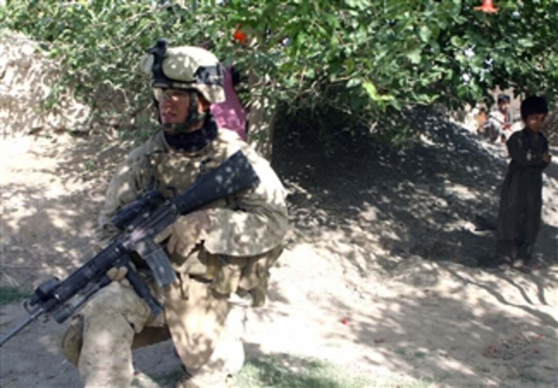 A U.S. Marine from Alpha Company, 1st Battalion, 6th Marine Regiment, 24th Marine Expeditionary Unit, International Security Assistance Force provides security during operations in Garmsir, Helmand Province, Afghanistan, on April 29, 2008.  