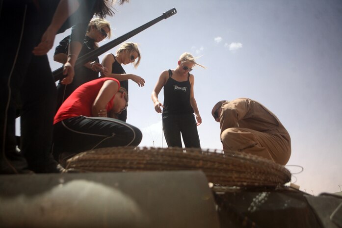 Lance Cpl. Matthew T. Enger, 20, a light armored vehicle driver from Morris, Illi., with Headquarters and Service Company, 2nd Light Armored Reconnaissance Battalion, Regimental Combat Team 5, shows the LAV to a group of Philadelphia Eagles cheerleaders during a visit at Camp Korean Village, Iraq, June 6. The cheerleaders visited residents aboard the base to show their support and appreciation for them defending the country.Lance Cpl. Matthew T. Enger, 20, a light armored vehicle driver from Morris, Illi., with Headquarters and Service Company, 2nd Light Armored Reconnaissance Battalion, Regimental Combat Team 5, shows the LAV to a group of Philadelphia Eagles cheerleaders during a visit at Camp Korean Village, Iraq, June 6. The cheerleaders visited residents aboard the base to show their support and appreciation for them defending the country.