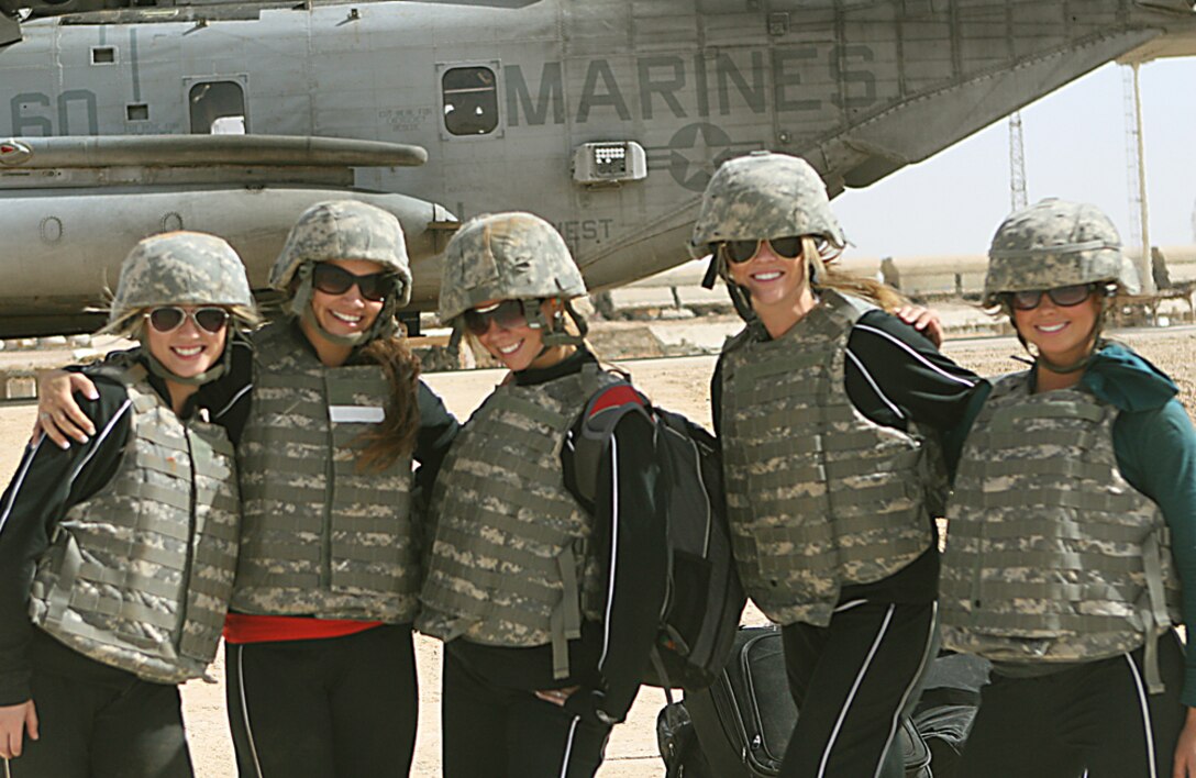 Philadelphia Eagles cheerleaders arrive at Camp Al Qa'im, Iraq, on a CH-53D Sea Stallion helicopter to sign autographs and meet the Marines and sailors of Task Force 2nd Battalion, 2nd Marines, Regimental Combat Team 5, June 6. The cheerleaders volunteered to go out and show support for deployed troops by putting on performances and visiting bases in Kuwait and Iraq.