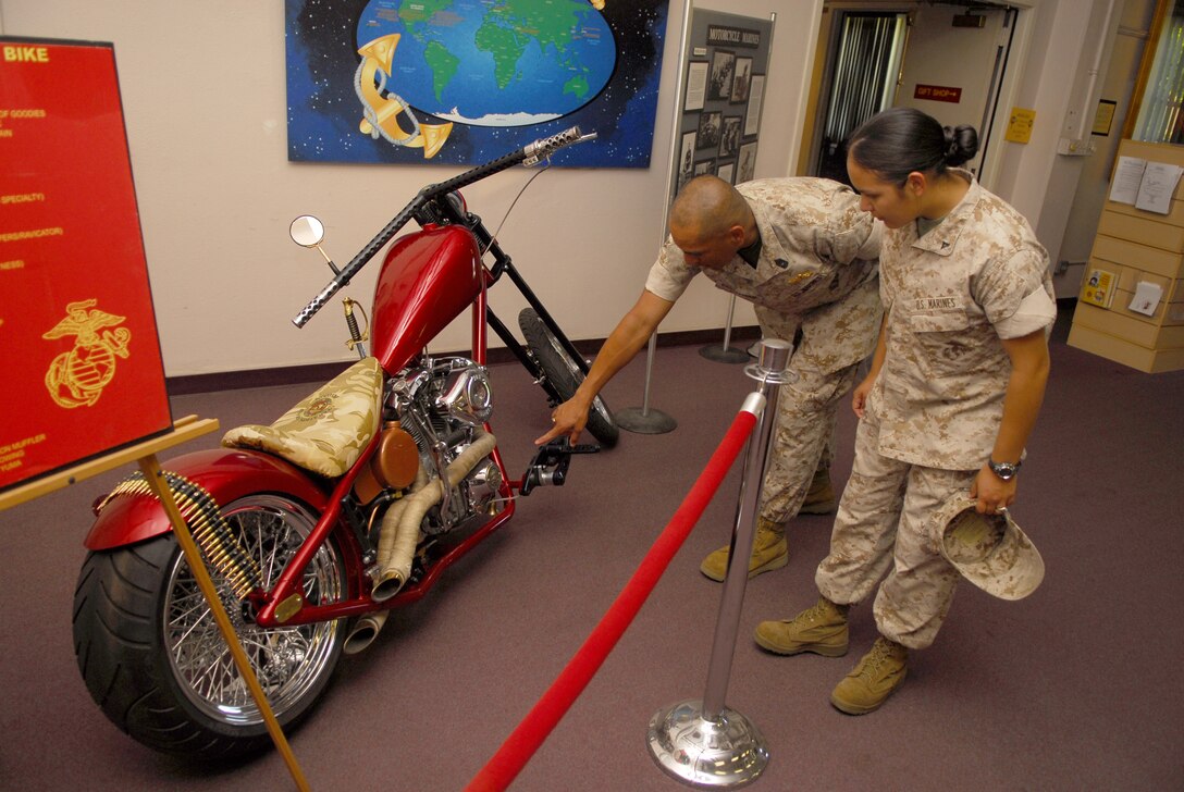 Marines touring the James L. Day Hall take a peek at retired Staff Sgt. Jerry Royal’s Operation Iraqi Freedom::r::::n::tribute bike, June 6. Royal, a native of Myrtle Beach, S.C., built the custom chopper using his own time, money::r::::n::and support from sponsors.