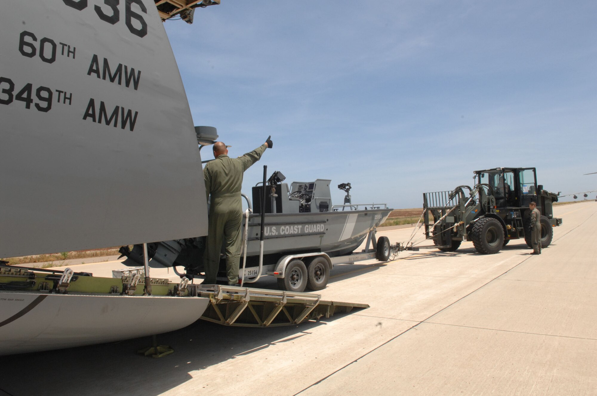 A Coast Guard patrol boat is unloaded from a Travis AFB C-5 during the Patriot Hook exercise.  Patriot Hook, a large-scale air mobility and contingency response exercise, took place in mid May for five days. An exercise that tests the viability of coordinated security, disaster and medical response operations, it involved some 300 people who moved approximately one and one-half million pounds of cargo from separate operating locations. Patriot Hook is a yearly largescale air mobility exercise involving Air Force Reserve Command airlift control flights, flying units and aerial port. The exercise provides a fully integrated combined joint task force and air mobility training in conjunction with individual training requirements. Participating affiliates this year included: U.S. Coast Guard, U.S. Navy, U.S. Army, FBI, FEMA, U.S. Border Patrol and U.S. Navy San Clemente staff. (U.S. Air Force photos by Senior Airman Erica J. Knight) 