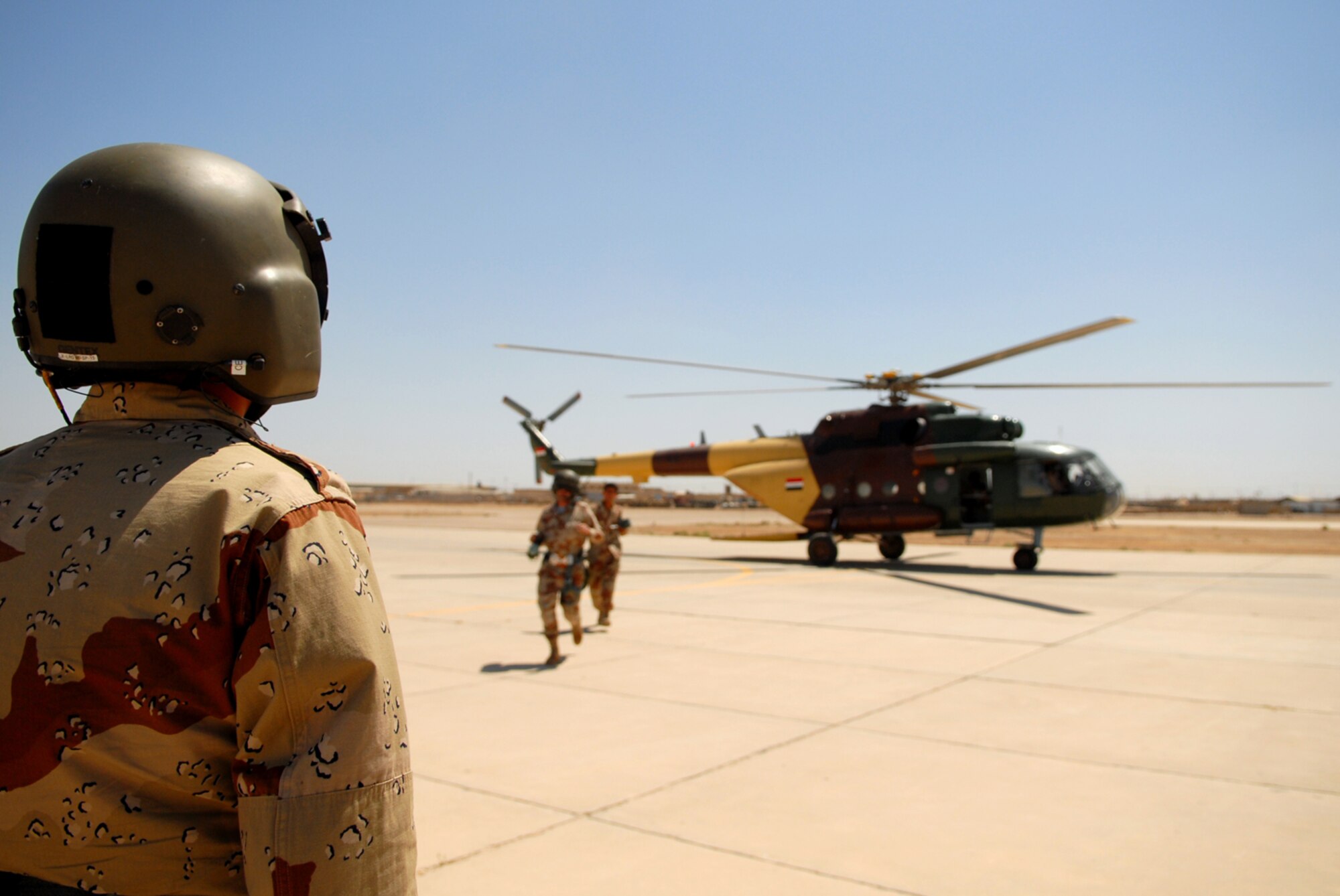 CAMP TAJI, Iraq -- Iraqi air force aerial gunner trainees exit an Mi-17 multi-role helicopter after a successful training mission over Camp Taji, May 29. The six-week aerial gunner training course is lead by Airmen with the 770th Air Expeditionary Advisory Squadron. (U.S. Air Force photo/ Senior Airman Julianne Showalter)