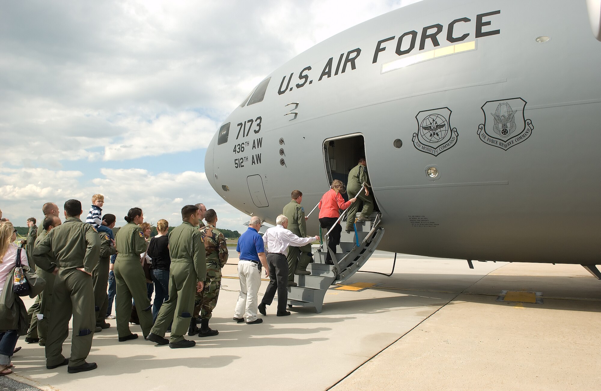 Dover Air Force Base personnel and loacl community leaders board the base's newest C-17 Globemaster III during the arrival ceremony May 22 at 4 p.m.  At 4 p.m. May 23, the base's newest C-17 carried a load of cargo on a channel mission to American forces deployed to Iraq.  (U.S. Air Force Photo/Jason Minto)