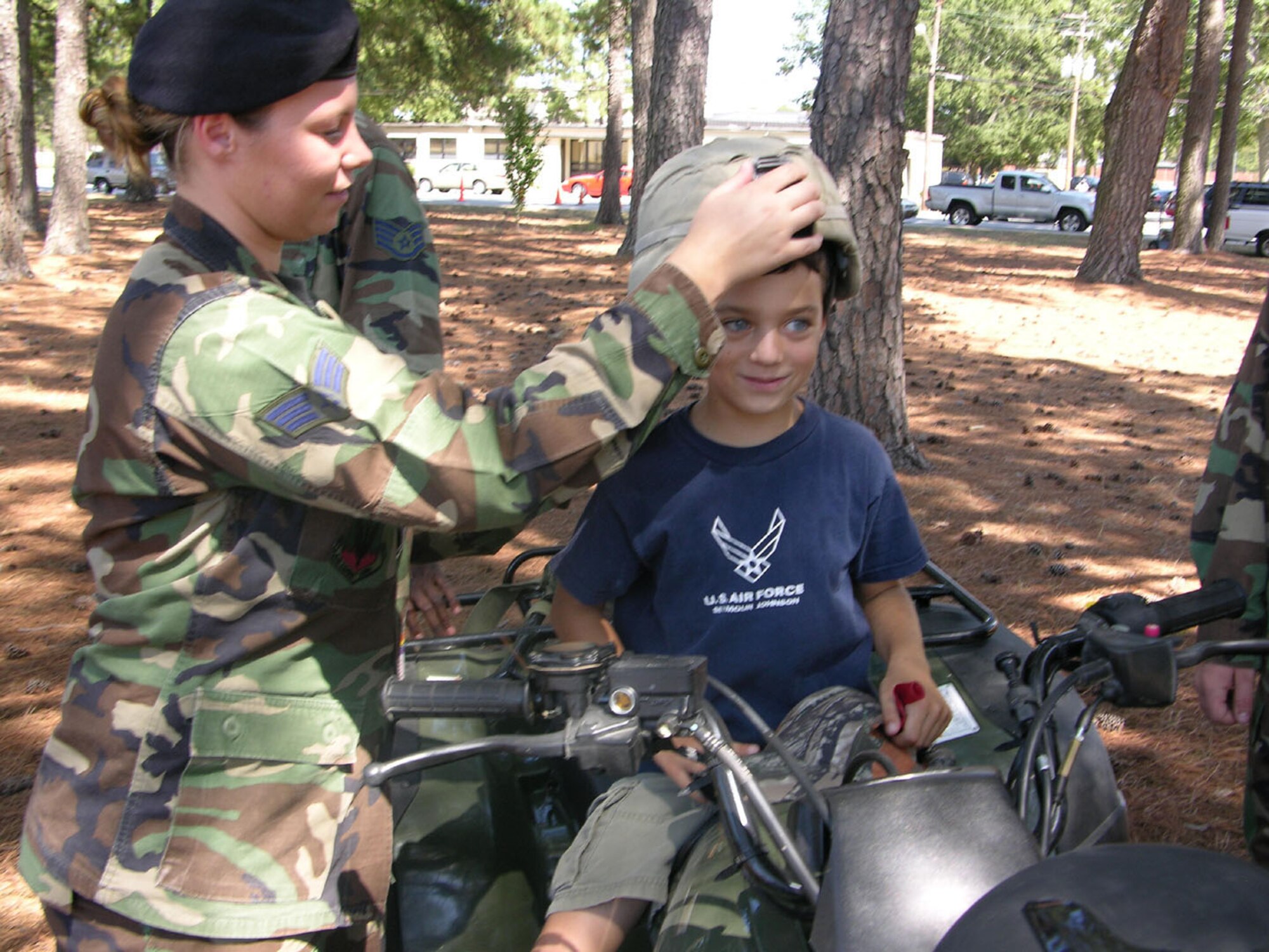 SEYMOUR JOHNSON AIR FORCE BASE, N.C. -- Senior Airman Amber Shirey assists a 916th Air Refueling Wing family member try on some security forces equipment during the 2007 Family Day. The date for the 2008 Family Day is Sat. Oct. 4 with events running from 11am to 4pm. A spouse's flight is scheduled to follow on Oct. 5. See first sergeants for more details.