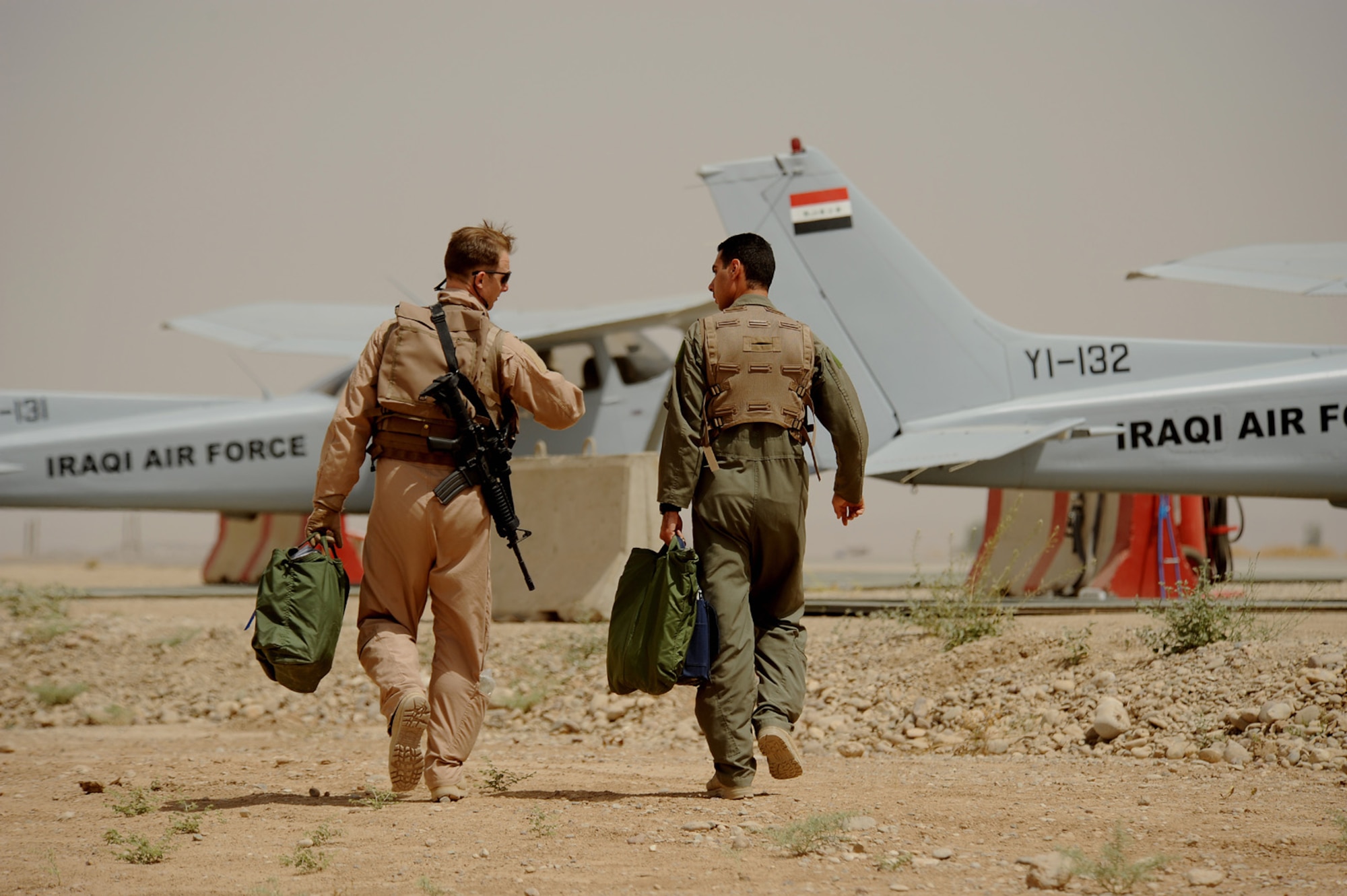 Capt. Jamie Riddle, 52nd Flying Training Squadron instructor pilot, and an Iraqi Flight Instructor School student engage in conversation prior to a recent sortie here. The Iraqi air force has continued rebuilding efforts to become a credible and capable military entity by recently establishing the Flight Instructor School (FIS) for Iraqi pilots. The school puts the most experienced of Iraq’s operational pilots into the classroom and cockpit at the Iraqi Flying Training Wing here in an effort to teach the fundamentals of flight instruction. (U.S. Air Force photo by Tech. Sgt. Jeffrey Allen)