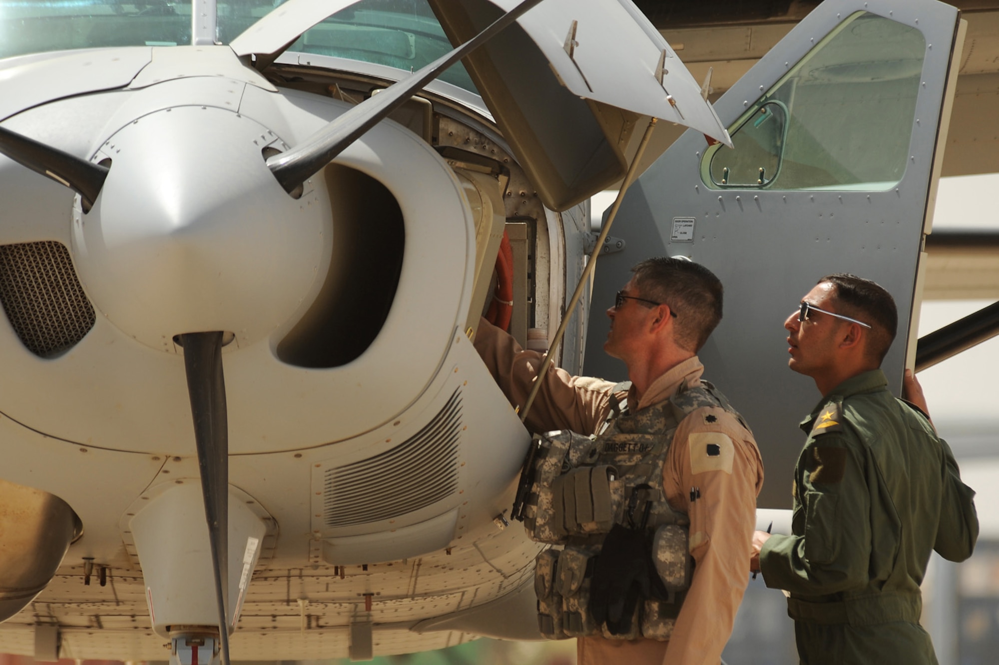 Lt. Col. Todd Daggett, 52nd Flying Training Squadron operations director, helps an Iraqi Flight Instructor School student with a pre-flight check before a recent sortie here. The Iraqi Air Force has continued rebuilding efforts to become a credible and capable military entity by recently establishing the Flight Instructor School (FIS) for Iraqi pilots. The school puts the most experienced of Iraq’s operational pilots into the classroom and cockpit at the Iraqi Flying Training Wing here in an effort to teach the fundamentals of flight instruction. (U.S. Air Force photo by Tech. Sgt. Jeffrey Allen)
