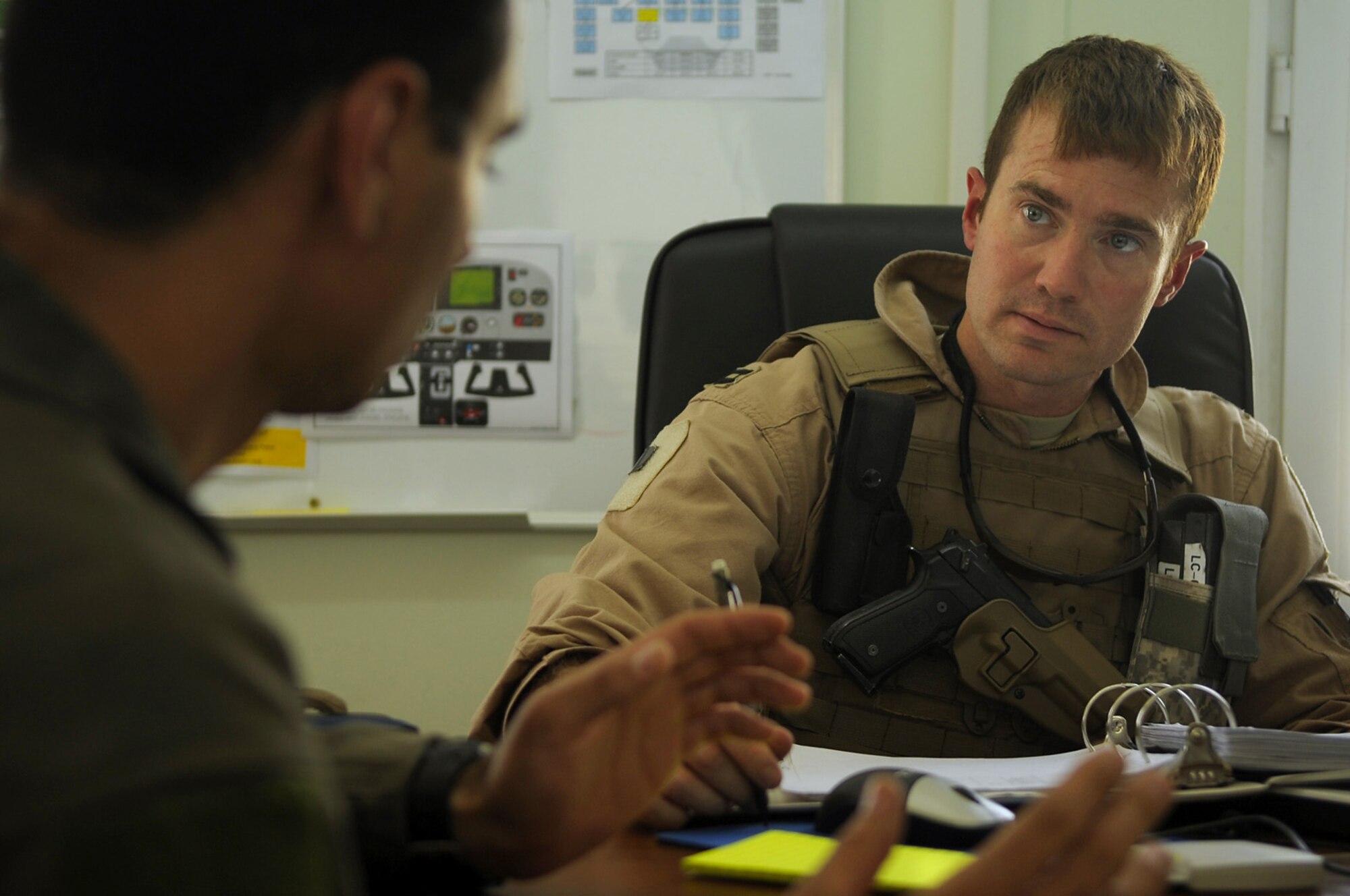 Capt. Brian Riggle, 52nd Flying Training Squadron instructor pilot, and an Iraqi Flight Instructor School student discuss flying techniques after a recent training sortie here. The Iraqi air force has continued rebuilding efforts to become a credible and capable military entity by recently establishing the Flight Instructor School (FIS) for Iraqi pilots. The school puts the most experienced of Iraq’s operational pilots into the classroom and cockpit at the Iraqi Flying Training Wing here in an effort to teach the fundamentals of flight instruction. (U.S. Air Force photo by Tech. Sgt. Jeffrey Allen)