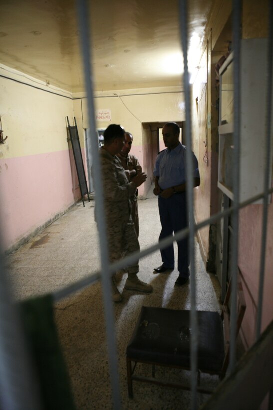 070608-M-4023M-001::r::::n::Staff Sgt. Luis C. Cardenas, detainee operations staff, Company B, Iraqi Transition Team 8, Regimental Combat Team 1, speaks with a detainee officer at Fallujah Major Crimes Prison in Fallujah, Iraq, June 7. Cardenas is from Kingwood, Texas, and works with prison officials to check on detainees. (Official Marine Corps photo by Cpl. Chris T. Mann)::r::::n::