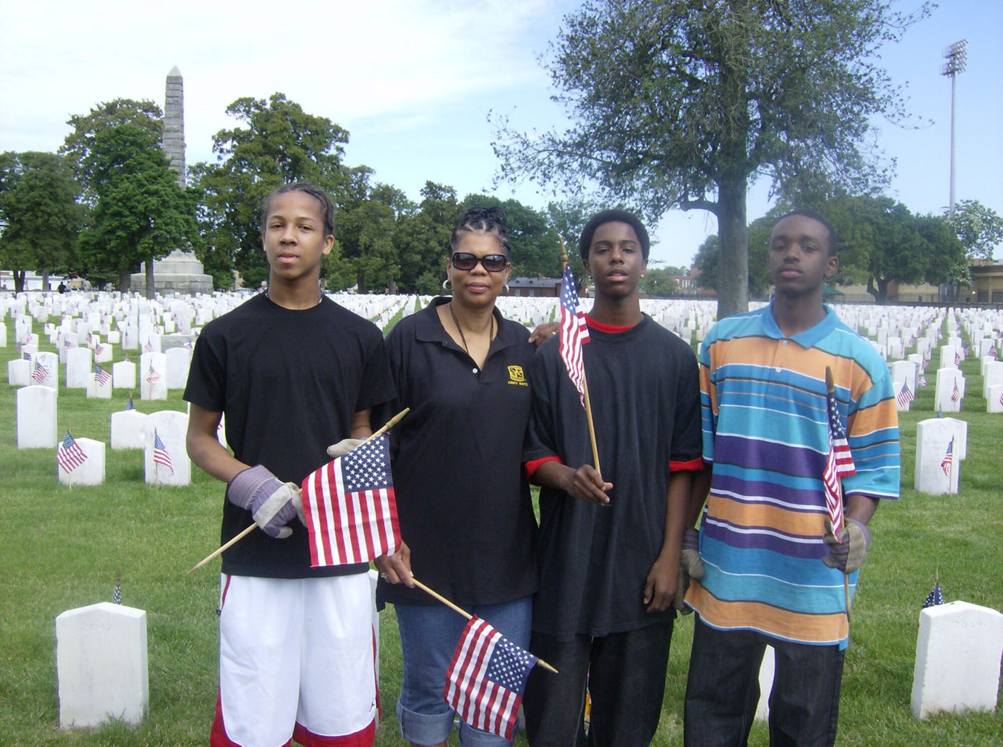SEYMOUR JOHNSON AIR FORCE BASE, N.C. -- First Sergeant Hazel Proctor (second from left) stands with her son and friends on Memorial Day as they place flags on the graves on fallen soldiers in Hampton, Virginia. Master Sgt. Proctor is a Reservist with the 916th Mission Support Flight.