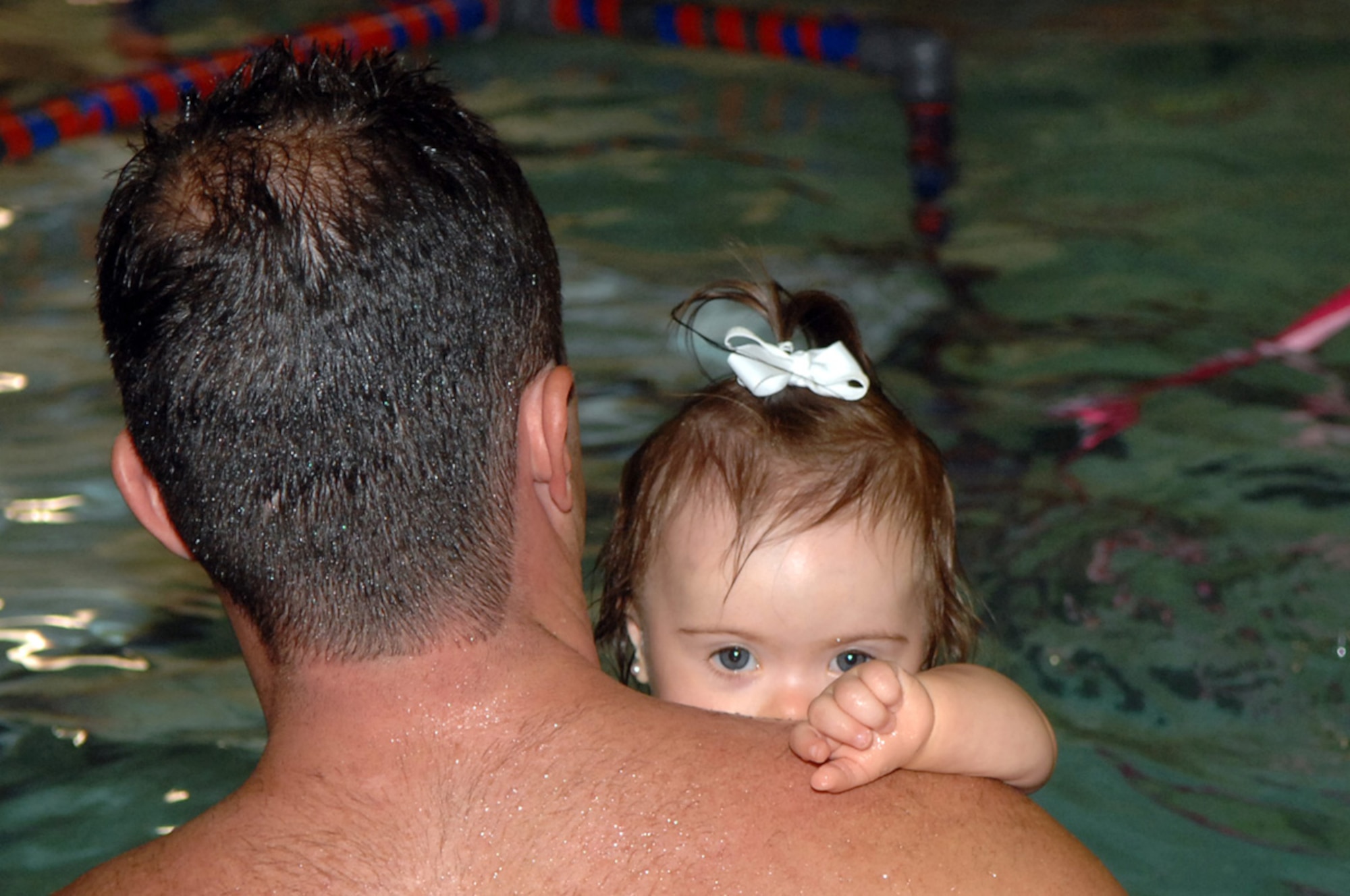 Heath White, member of the 93d Bomb Squadron, helps his youngest daughter, Paisley, learn how to swim Thursday, May 5, at a local swim school in Shreveport, La. (U.S. Air Force photo/Airman 1st Class Joanna Kresge)