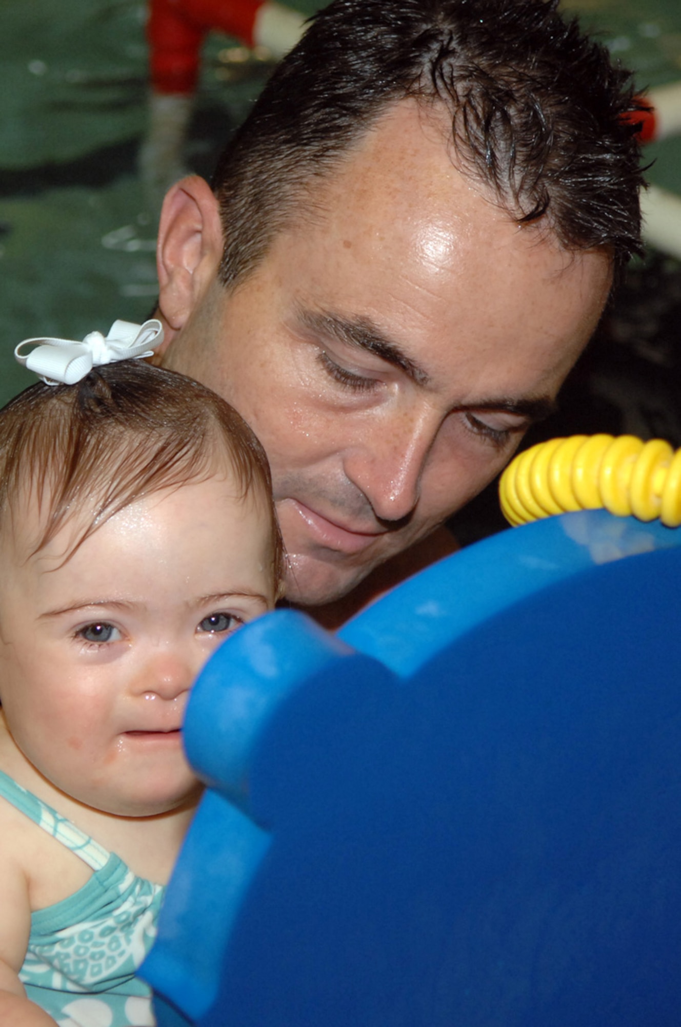 Heath White, member of the 93d Bomb Squadron, helps his youngest daughter, Paisley, learn how to swim Thursday, May 5, at a local swim school in Shreveport, La. (U.S. Air Force photo/Airman 1st Class Joanna Kresge)