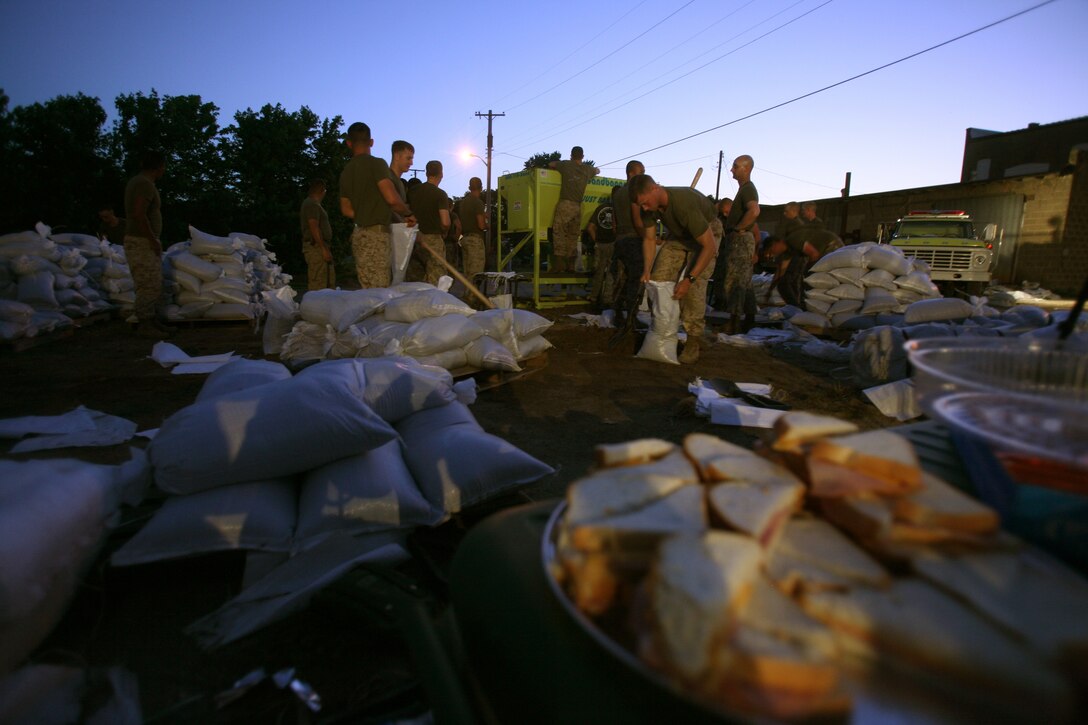 Freshly made sandwiches wait while Marines and sailors of Battalion Landing Team 2/6, 26th Marine Expeditionary Unit fill sand bags June 9, 2008, in Elnora, Ind. The Marines and sailors began working at 4 a.m. and continued their efforts throughout the day.  Local authorities in Elnora requested the 26th MEU to provide support to reinforce the levees from flooding of the White River. ::r::::n::
