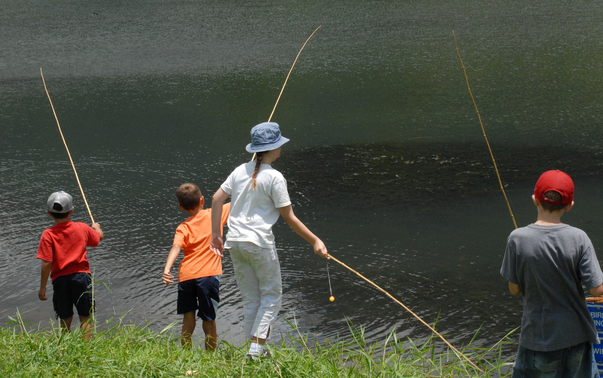 Children fish during the 9th Annual Keiki Fishing Tournament, June 6, at Ho'omaluhia Botanical Gardens, Kaneohe, Hi. About 150 children came out to the event, sponsored by Friends of Hickam. (U.S. Air Force photo/Staff Sgt. Erin Smith)