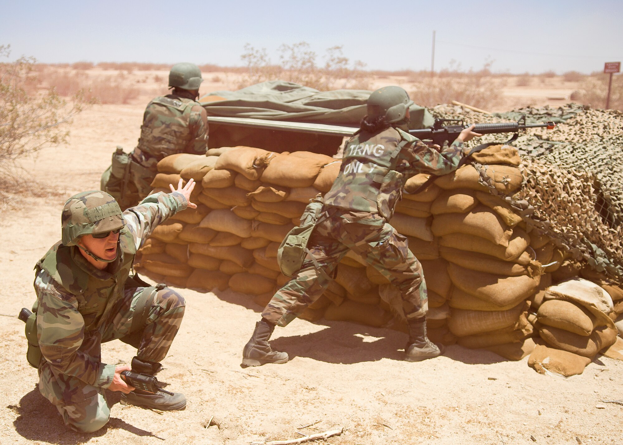 Edwards Airmen defend a bunker during a simulated attack at Camp Corum here June 6 during the base's operational readiness exercise. During the exercise from June 2 to 6, Edwards was evaluated on deployment line processing and deployment operations at Camp Corum. (Air Force photo by Mike Cassidy)