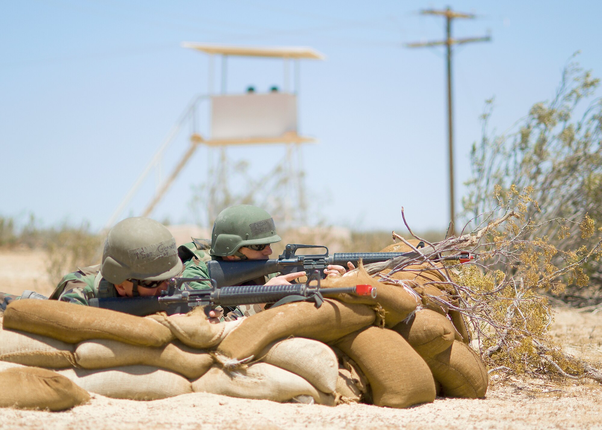 Two Edwards Airmen practice base security measures at Camp Corum during Phase II of the operational readiness exercise. The Phase II of the ORE tested Edwards Airmen’s ability to survive and operate in a deployed location. (Air Force photo by Mike Cassidy)