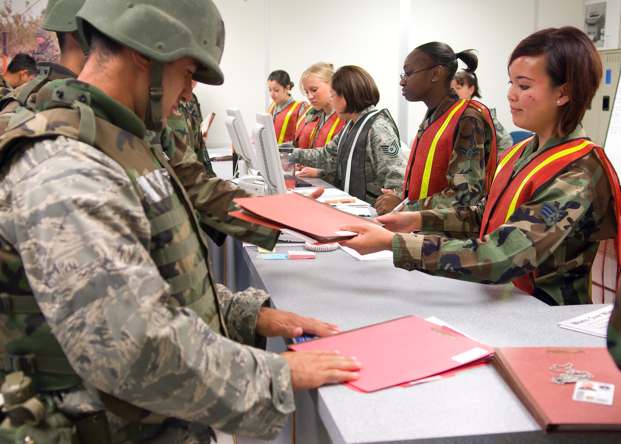 Airmen with the 95th Force Support Squadron process “deploying” Airmen during an operational readiness exercise here. (Air Force photo by Mike Cassidy)