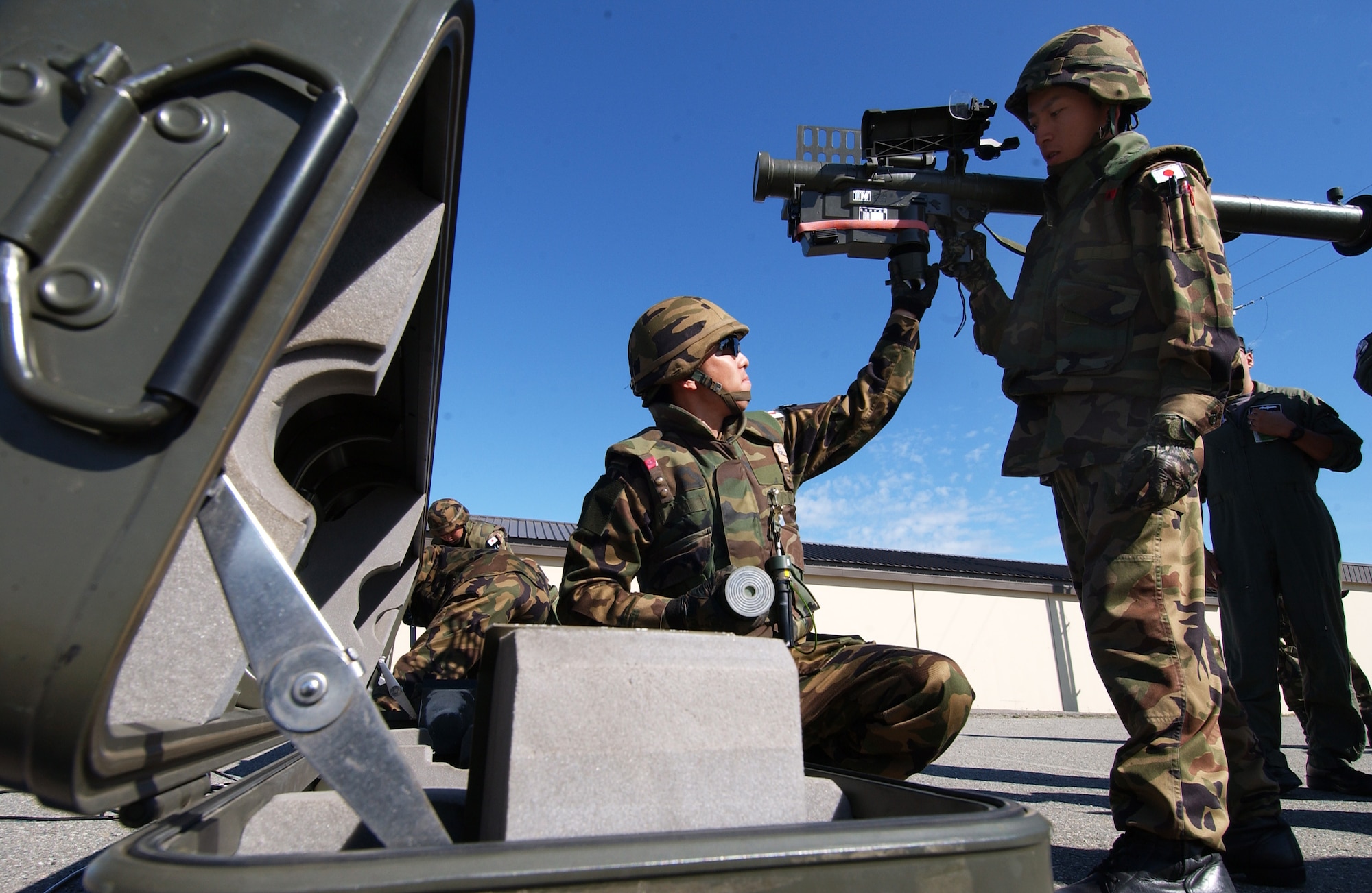 Staff Sgt. Masanori Soma, left, replaces a battery pack on a stinger while Staff Sgt. Akira Takahashi holds it in place June 6, 2008, at Eielson Air Force Base, Alaska during RED FLAG-Alaska 08-3. The Japanese Air Self Defense Force hosts a demonstration showing other Red Flag participants how their stinger team operates. (U.S. Air Force Photo/Airman 1st Class Jonathan Snyder)