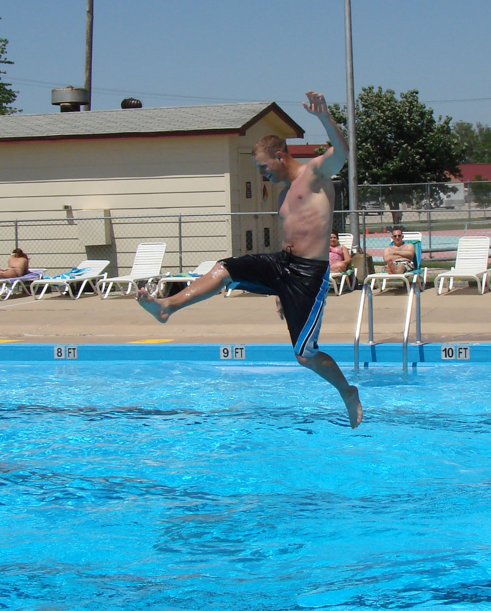 First Lt. Jimmy Arnold dives into the Plains Pool at Vance Air Force Base, Okla. A new $80,000 liner will keep the pool open for many summers to come. Lieutenant Arnold is assigned to fly C-17s in Hawaii after follow-on training at Altus AFB, Okla. (U.S. Air Force photo by Joe Wiles)