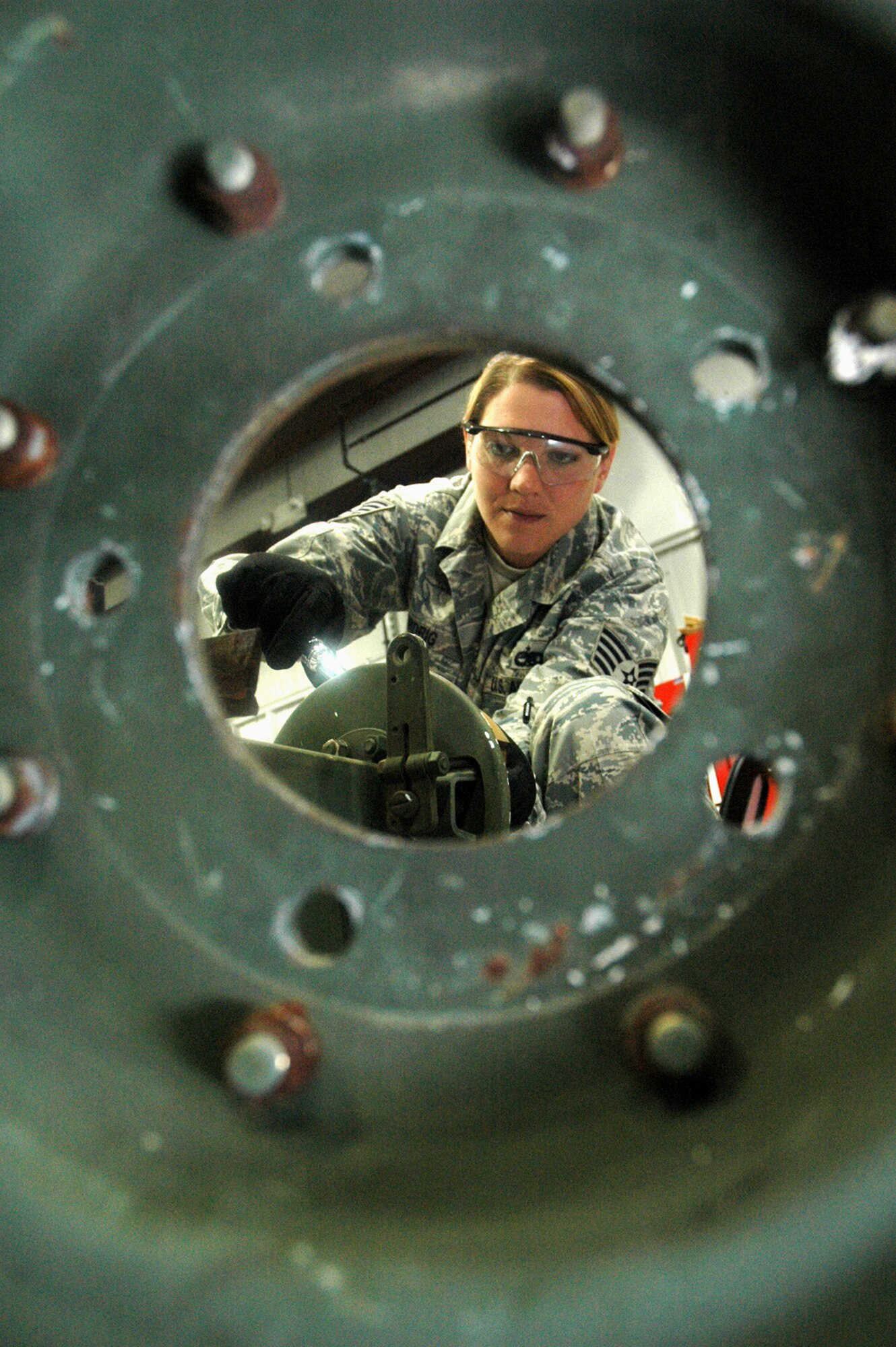 Staff Sgt. Jamie Widrig, instructor and course director for the Mobile Command and Control Generator Course for the U.S. Air Force Expeditionary Center's Mobility Operations School at Fort Dix, N.J., works on the axle for a generator stand June 5, 2008, at the Center.  Annually, the USAF EC trains more than 23,000 students in expeditionary- and mobility air force-based courses both with in-residence and distance learning.  (U.S. Air Force Photo/Tech. Sgt. Scott T. Sturkol)