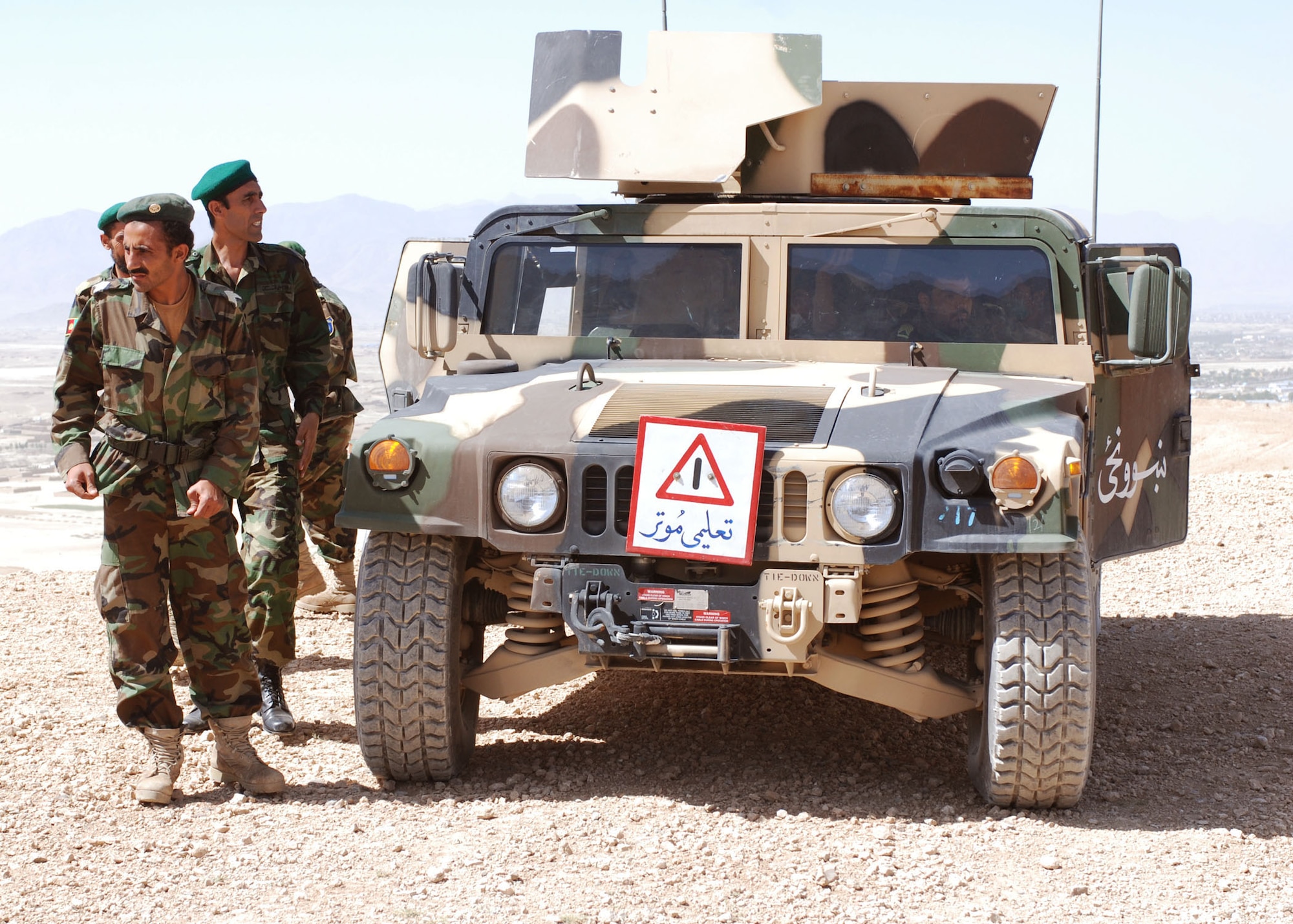 Soldiers from the Afghan National Army train in Humvees at the Kabul Military Training Center in Kabul, Afghanistan. The five-month course is led by Capt. Todd Klusek and Army Capt. William Snyder and teaches ANA soldiers how to properly maintain and operate Humvees. To date, 75 ANA soldiers have graduated the course with some returning as course instructors. (U.S. Navy photo/Petty Officer 1st Class Douglas)
