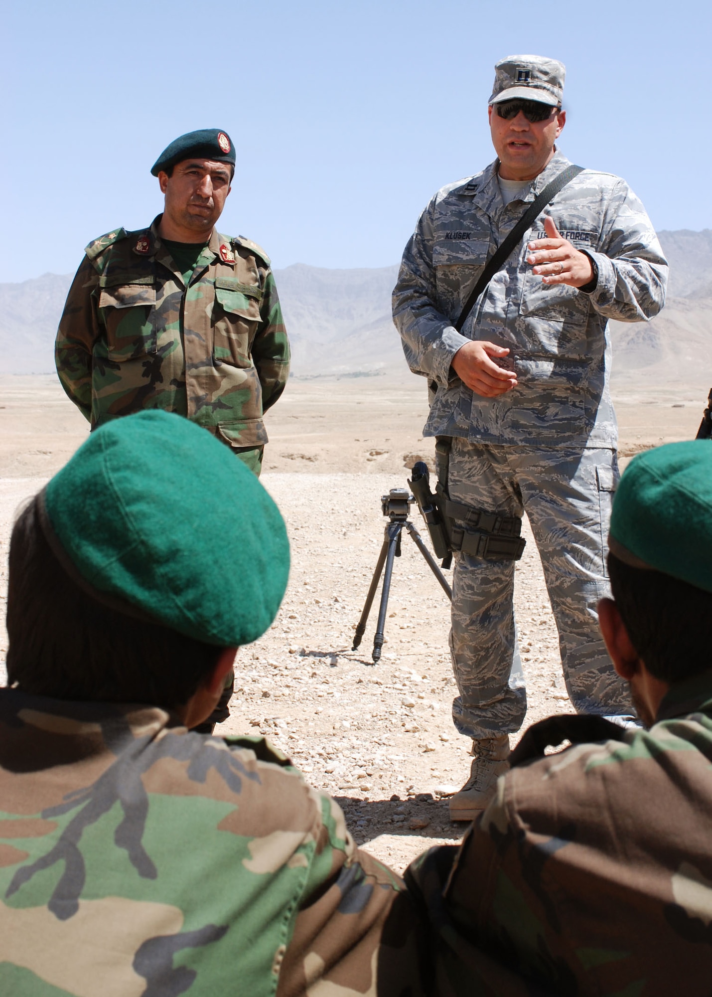 Capt. Todd Klusek explains a drivers' safety issue regarding Humvee rollovers to Afghan National Army soldiers during Humvee training at the Kabul Military Training Center in Kabul, Afghanistan. Captain Klusek serves as a combat service support senior mentor for the center's Humvee Driving course. Captain Klusek is deployed from of Dyess Air Force Base, Texas. (U.S. Navy photo/Petty Officer 1st Class Douglas)
