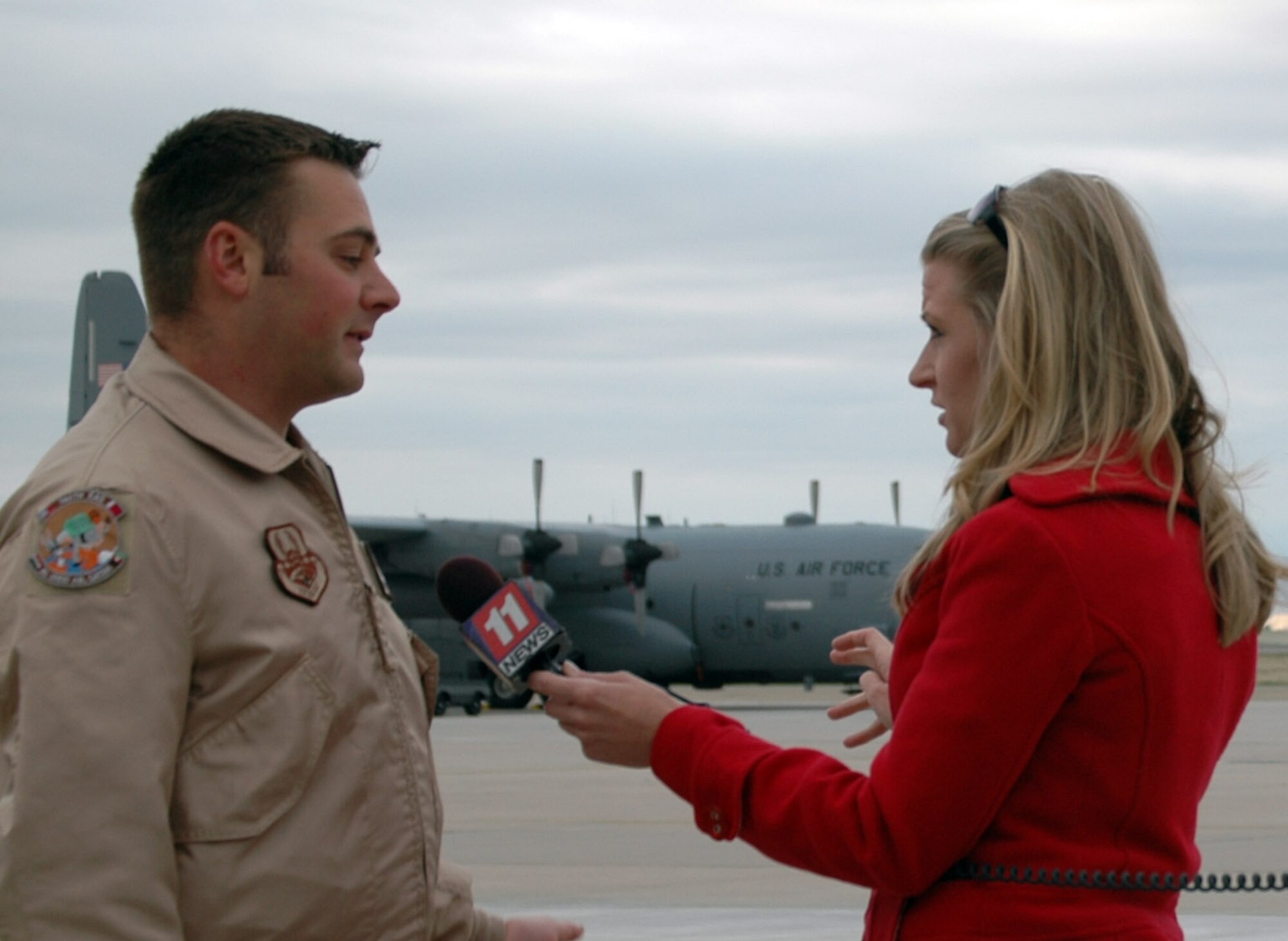 Technical Sgt. Matthew D. Fenton, a flight engineer with the 731st Airlift Squadron 
answers questions from Ms. Lauri Martin, KKTV reporter in Colorado Springs. 
Members of the 302nd Airlift Wing at Peterson Air Force Base recently deployed 
in support of ongoing operations in the Middle East.  Members are employed 
civilians who volunteer as Air Force Reservists.  (U.S. Air Force Photo/ By Ann Skarban)
