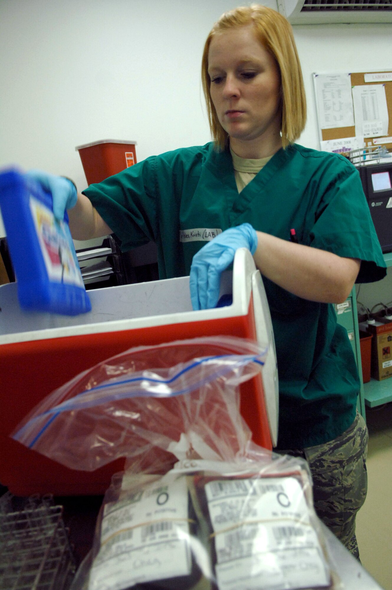 Senior Airman Kristi Hales places ice packs into a cooler for a grab-and-go kit used to respond to emergency patient situations at the Air Force Theater Hospital June 5 at Balad Air Base, Iraq. Airman Hales is a 332nd Expeditionary Medical Support Squadron lab technician deployed from Lackland Air Force Base, Texas. (U.S. Air Force photo/Senior Airman Julianne Showalter) 
