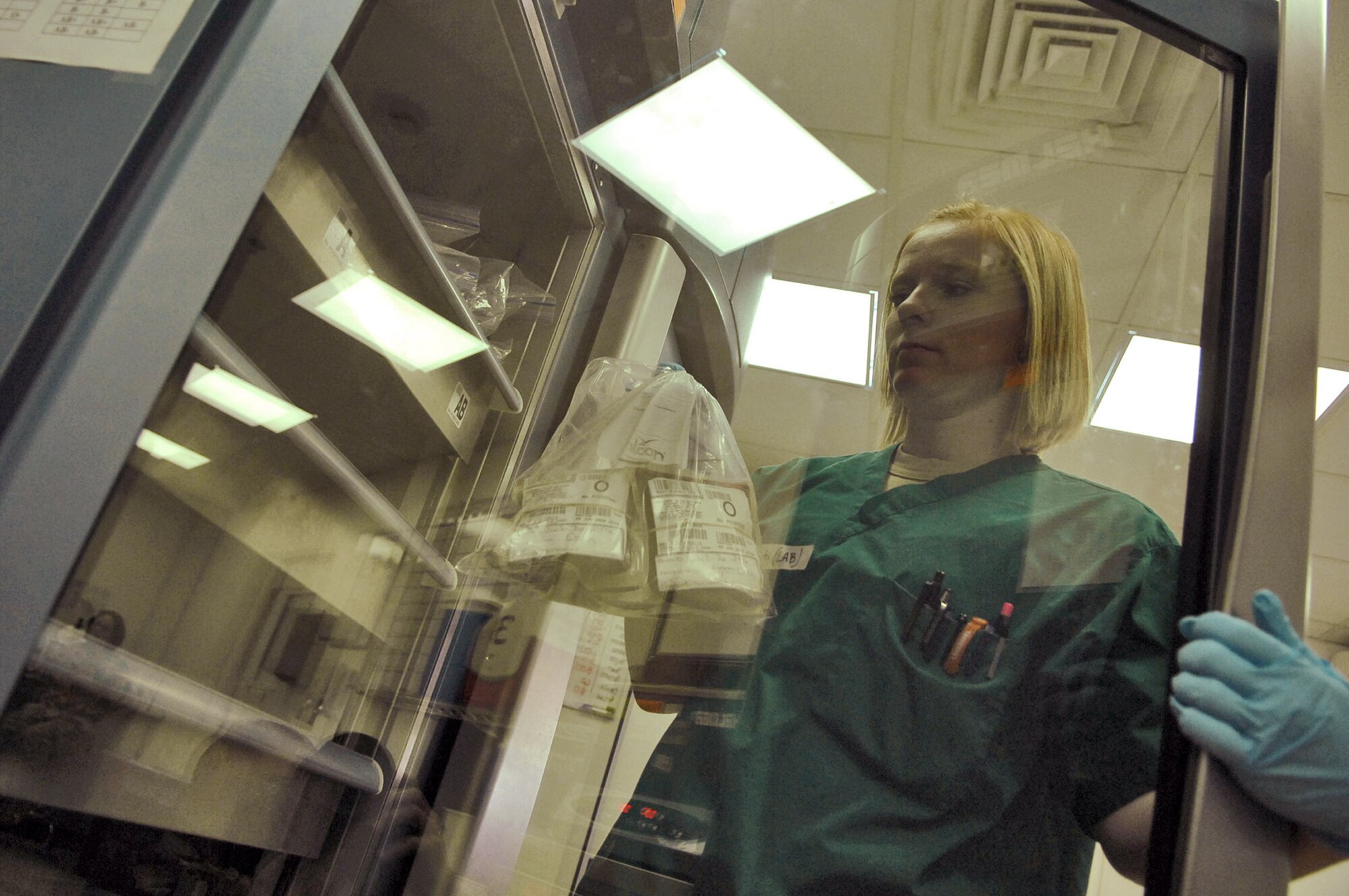 Senior Airman Kristi Hales pulls blood products out of a refrigerator to be used for a patient in the emergency room at the Air Force Theater Hospital June 5 at Balad Air Base, Iraq. Lab technicians are on constant alert for emergency situations and have kits prepared for any potential casualties arriving in the emergency room or operating room. Airman Hales is a 332nd Expeditionary Medical Support Squadron lab technician deployed from Lackland Air Force Base, Texas. (U.S. Air Force photo/Senior Airman Julianne Showalter) 
