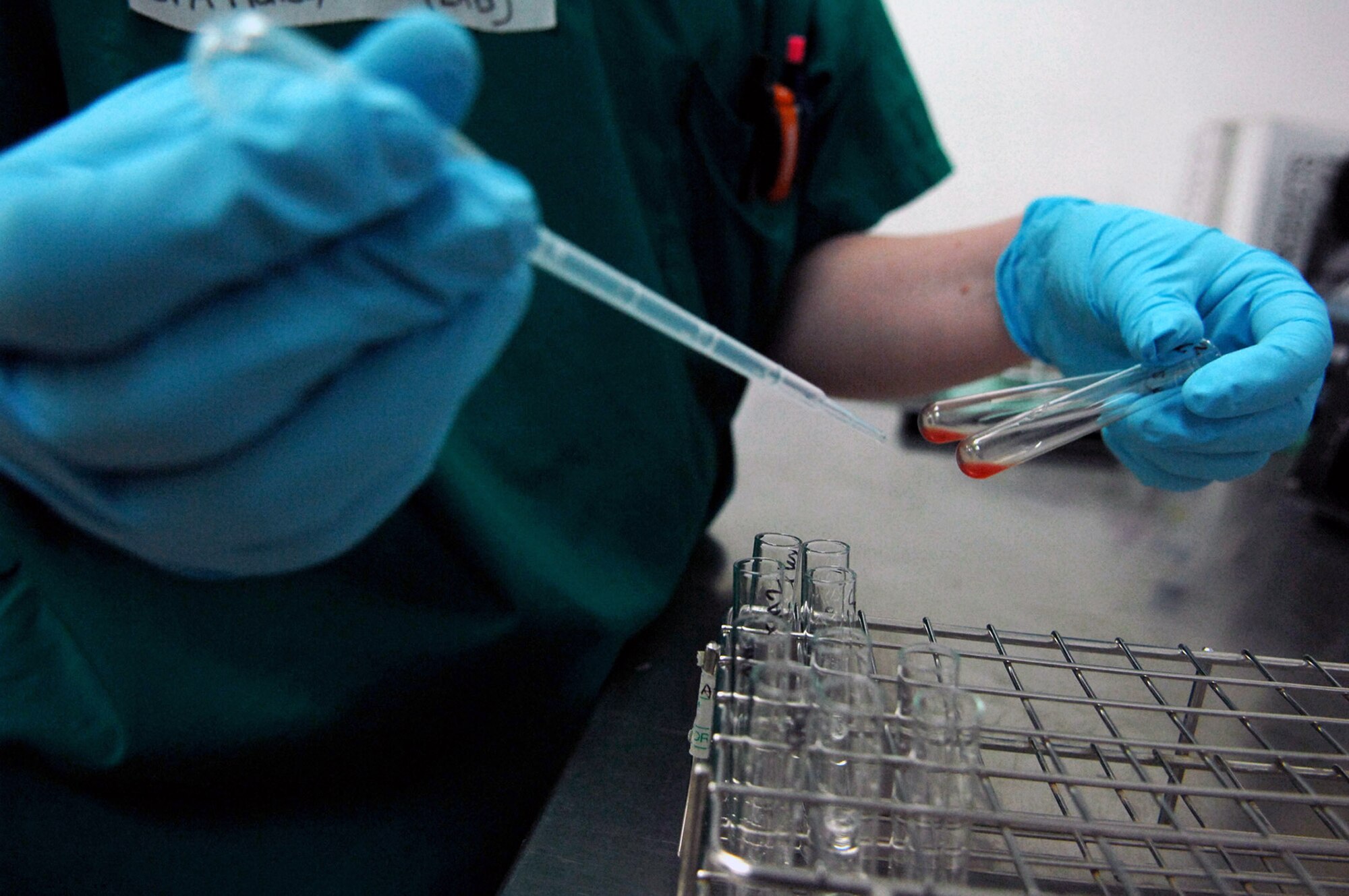 Senior Airman Kristi Hales puts saline into small vials of blood to determine the blood type of a trauma patient at the Air Force Theater Hospital June 5 at Balad Air Base, Iraq. Blood typing enables the technicians to give the correct type of blood product to the patient. Airman Hales is a 332nd Expeditionary Medical Support Squadron lab technician deployed from Lackland Air Force Base, Texas. (U.S. Air Force photo/Senior Airman Julianne Showalter 
