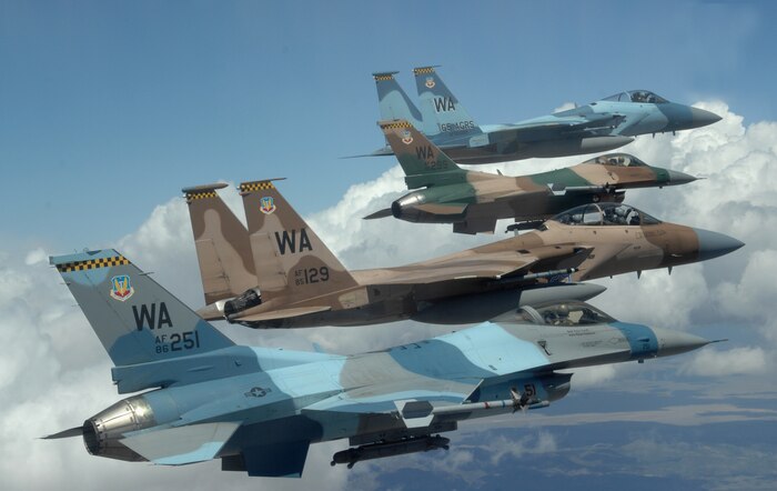 A flight of Aggressor F-15 Eagles and F-16 Fighting Falcons fly in formation over the Nevada Test and Training Ranges on June 5, 2008. The jets are assigned to the 64th and 65th Aggressor Squadrons at Nellis Air Force Base, Nev. The Aggressor mission is to prepare the combat air forces, joint and allied aircrews for tomorrowÕs victories with challenging and realistic threat replication, training, academics and feedback.
(U.S. Air Force photo/ Master Sgt. Kevin J. Gruenwald)