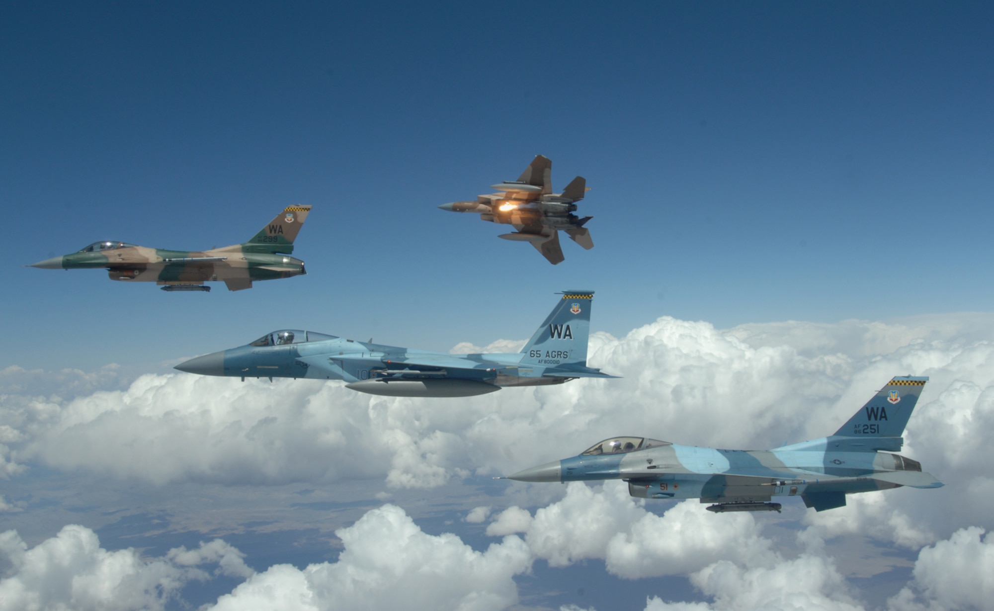 A flight of Aggressor F-15 Eagles and F-16 Fighting Falcons fly in formation over the Nevada Test and Training Ranges on June 5, 2008. The jets are assigned to the 64th and 65th Aggressor Squadrons at Nellis Air Force Base, Nev. The Aggressor mission is to prepare the combat air forces, joint and allied aircrews for tomorrowÕs victories with challenging and realistic threat replication, training, academics and feedback.
(U.S. Air Force photo/ Master Sgt. Kevin J. Gruenwald)